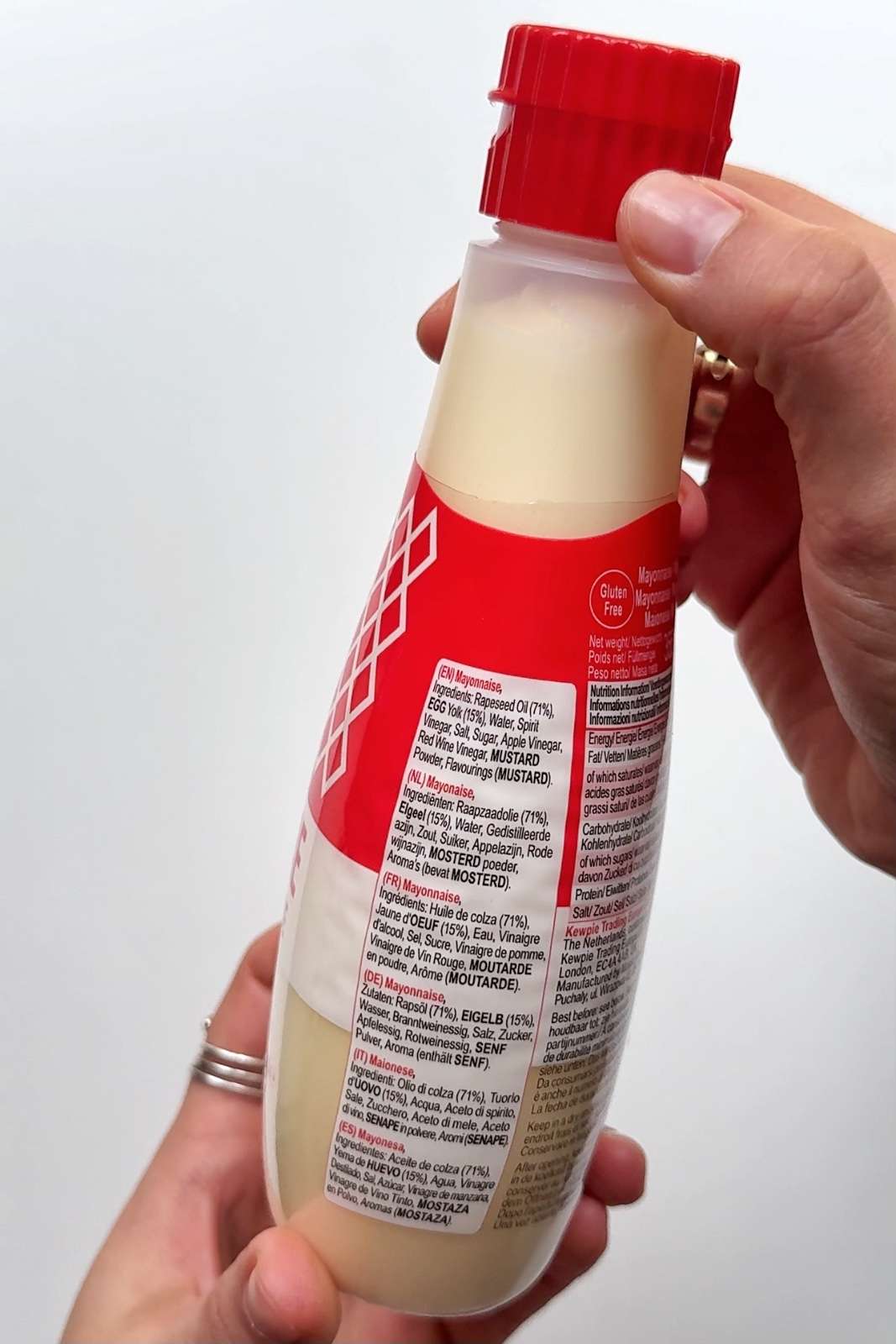 Back label of a Kewpie mayonnaise bottle showing the ingredients list in multiple languages.