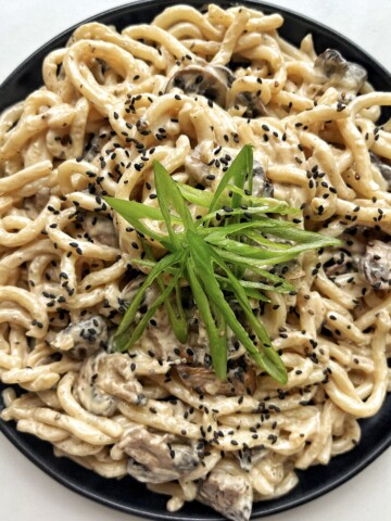 Creamy Udon recipe on a black plate