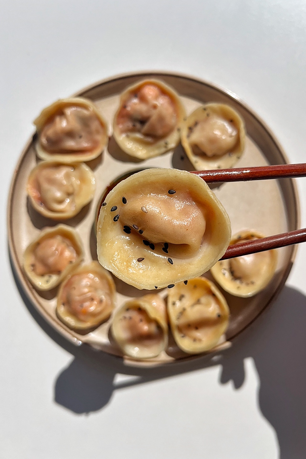 Close up of a dumpling with kimchi and tofu.