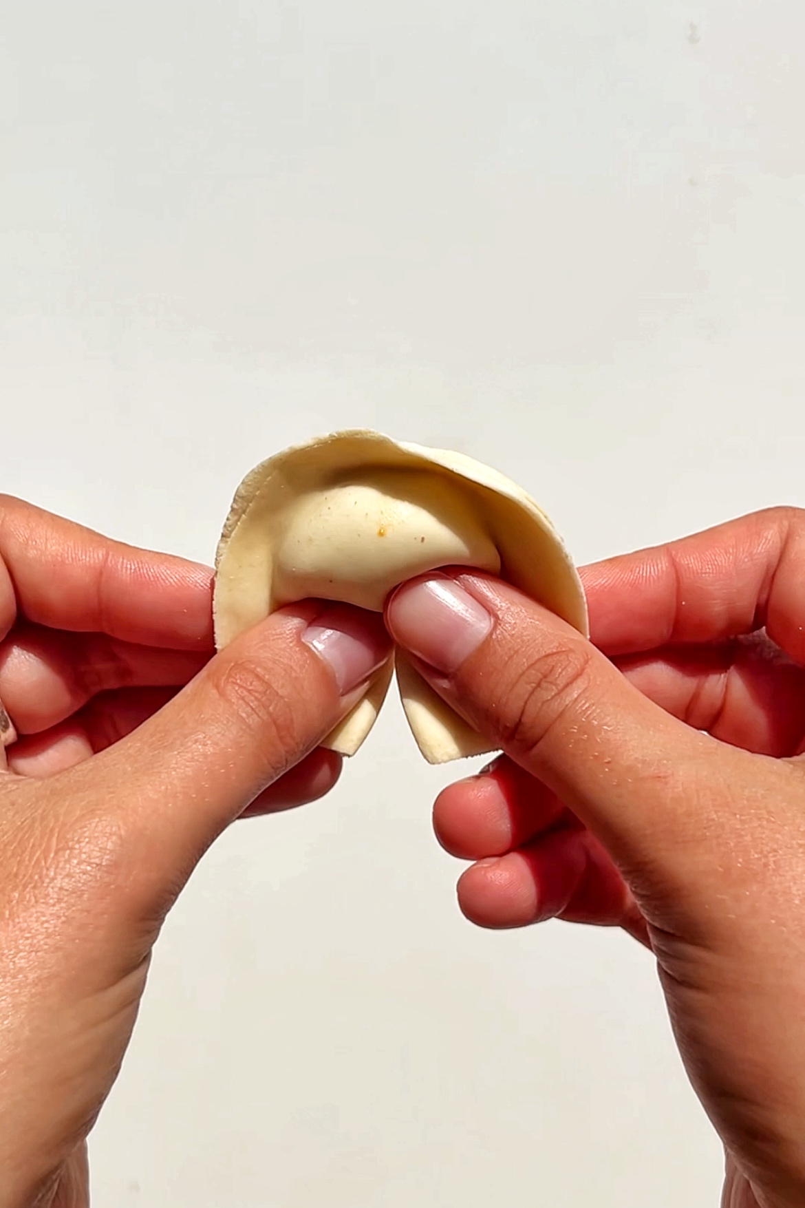 Folding a dumpling.