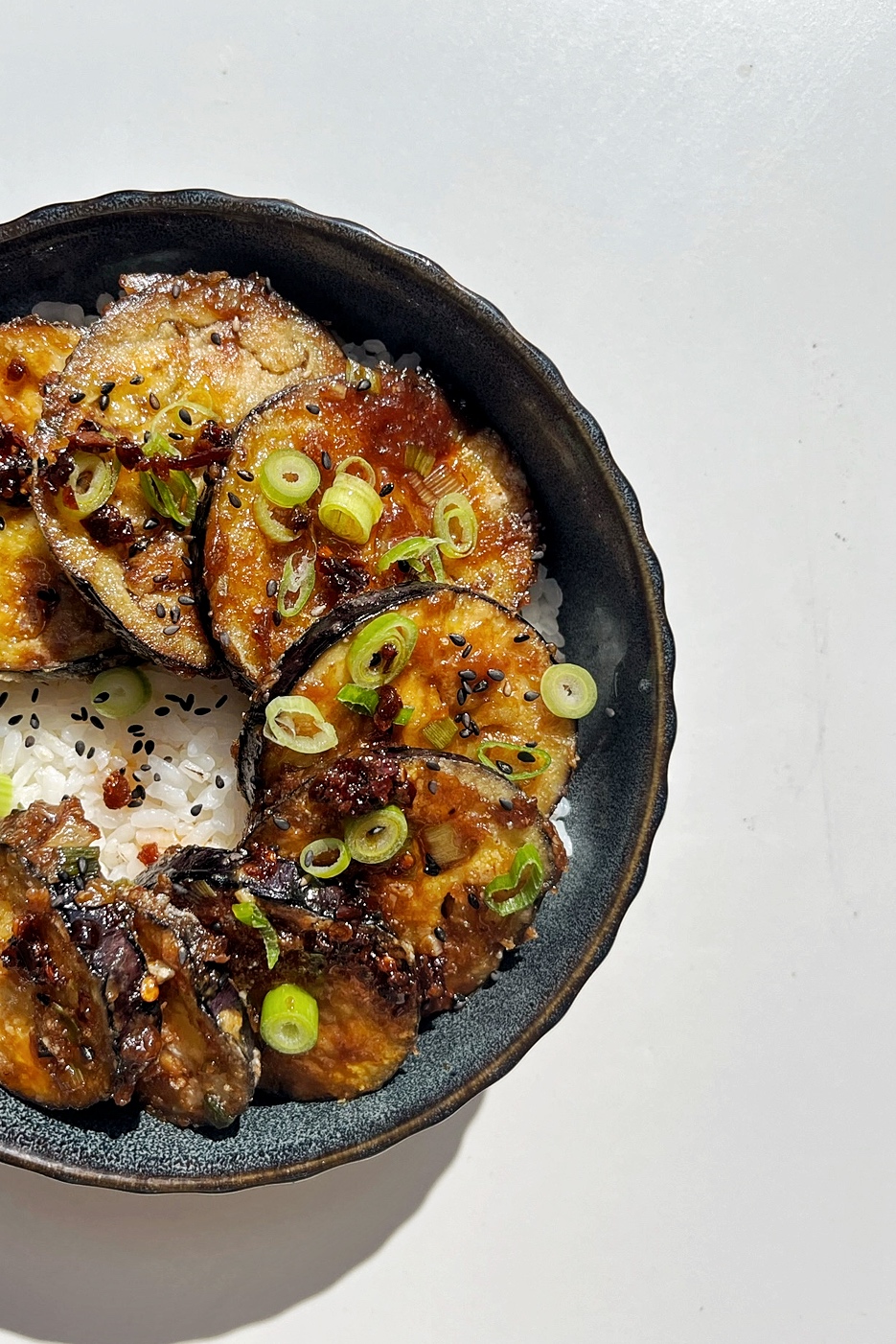 Half photo of sticky miso aubergine. 