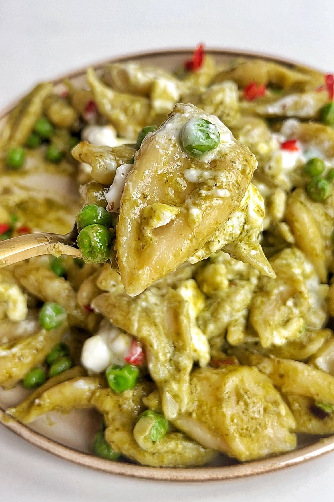 Close up of a piece of scissor cut pasta with tofu.