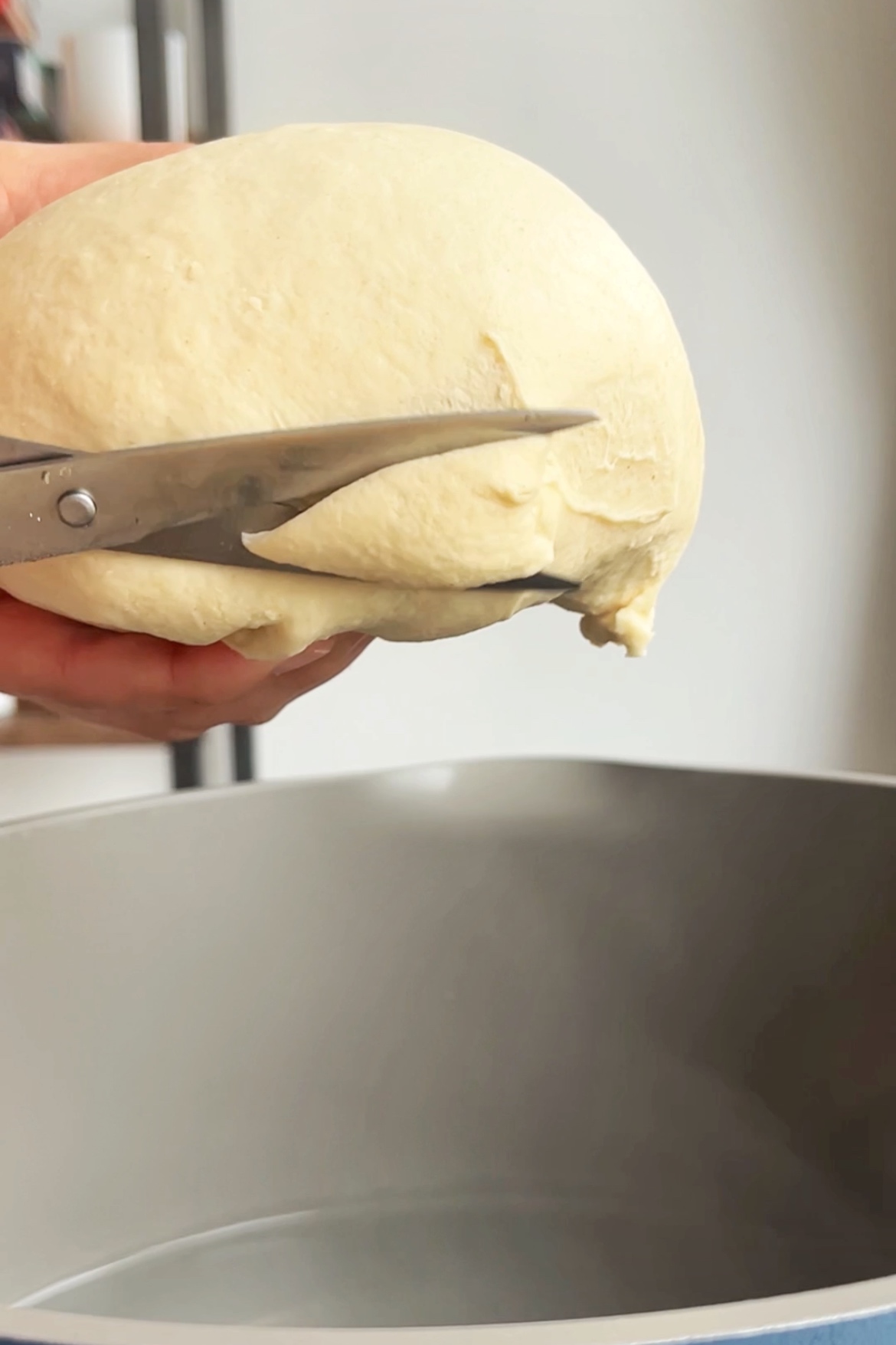Cutting the pieces of dough into scissor cuts.