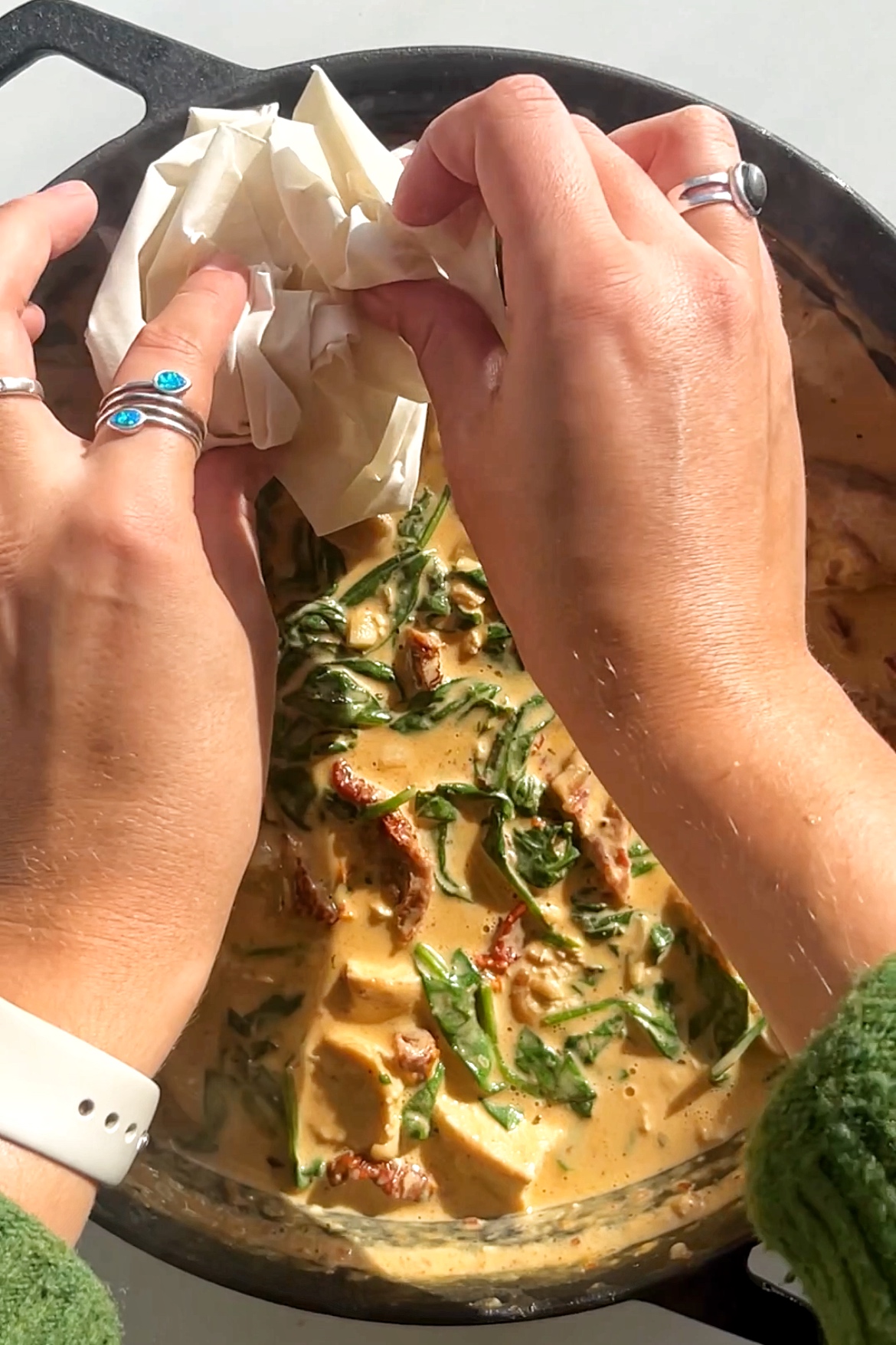 Placing crumpled filo pastry onto of pie mixture.