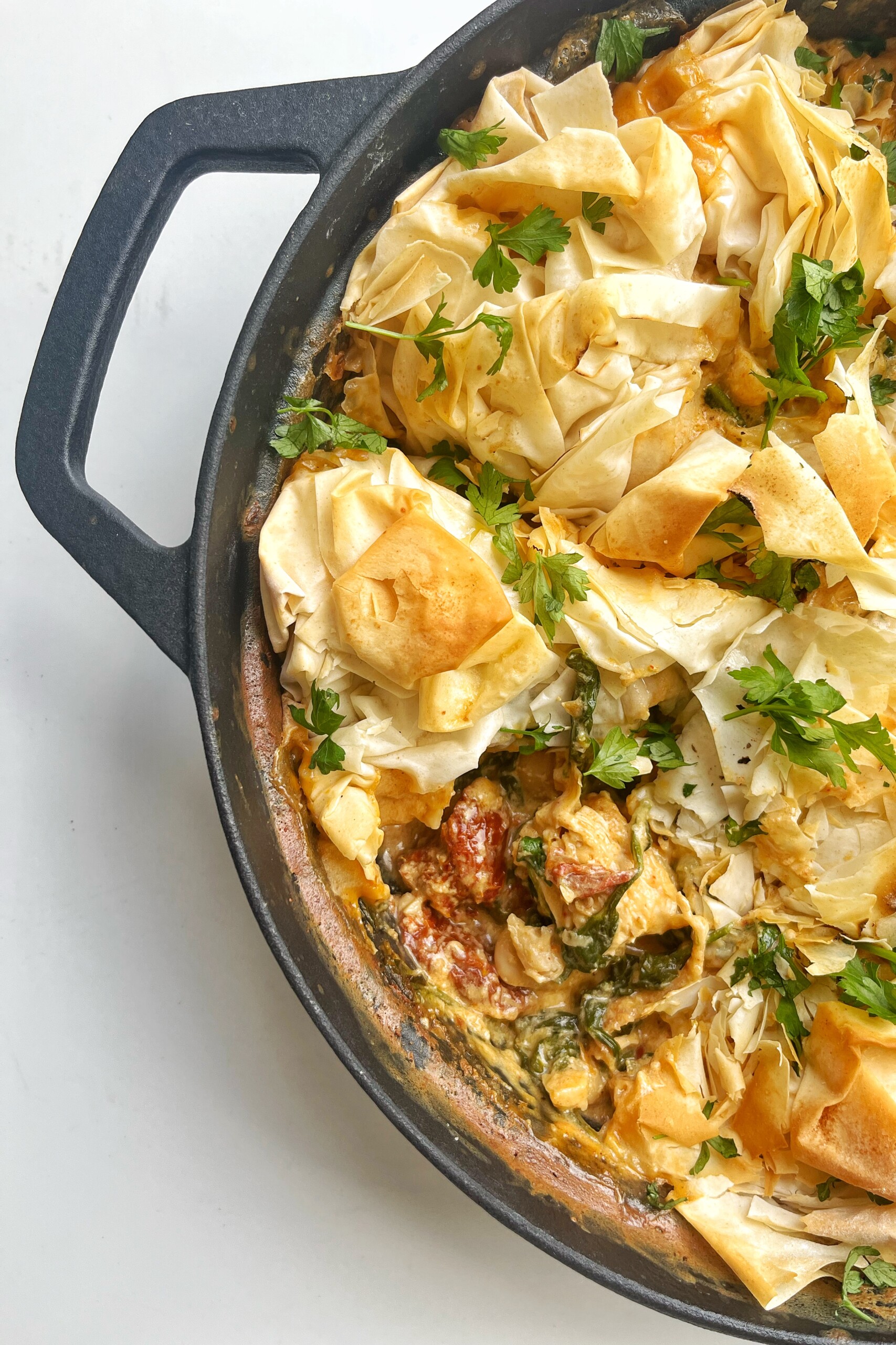 Marry me chicken pie in black oven-proof skillet.