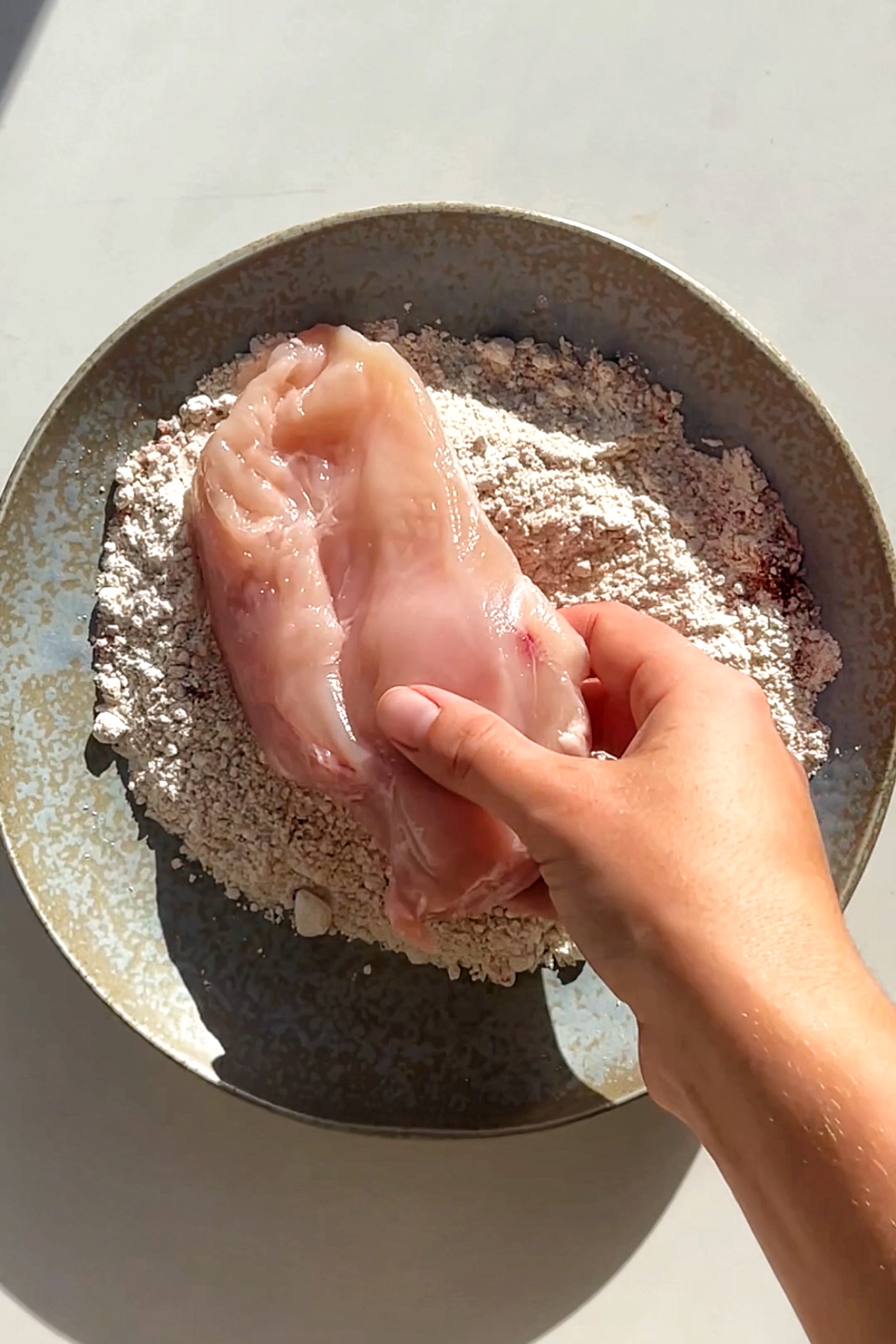 Dredge chicken breast in flour mixture.