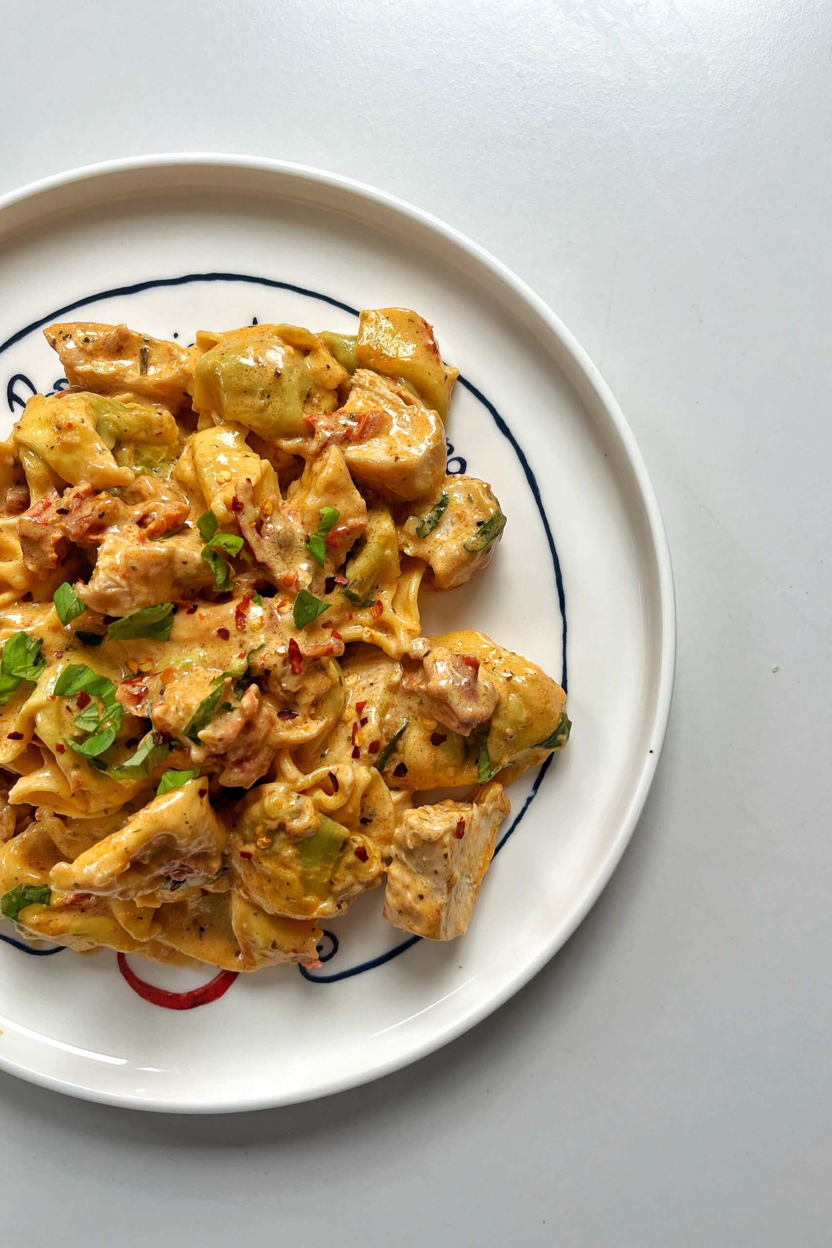 Side picture of marry me chicken and tortellini.