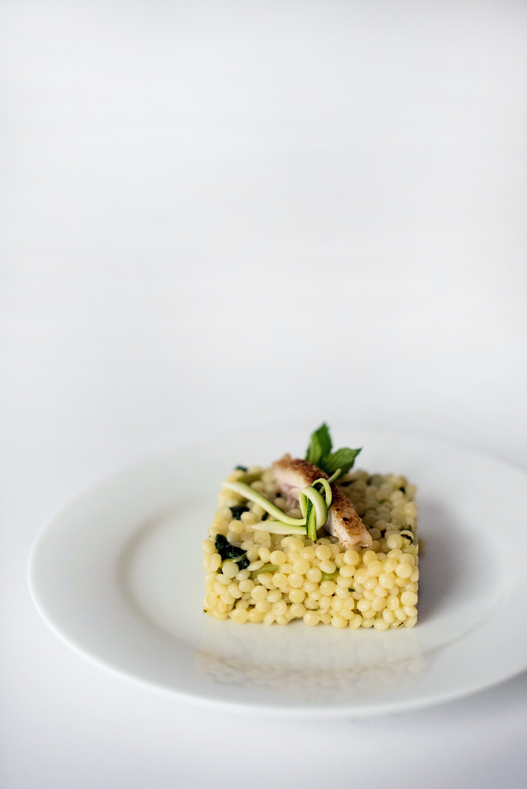 Pearl couscous or giant couscous on a plate.