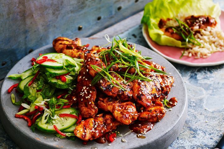 Chicken with gochujang and cucumber on a plate.