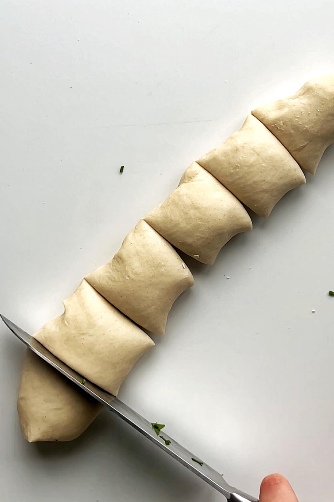 Slicing up dough into small equal pieces.