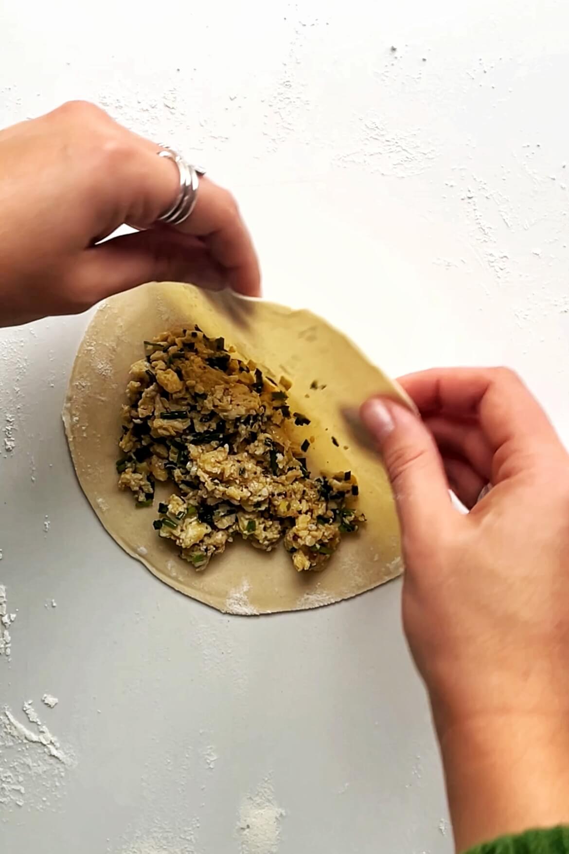 Assembling chive pocket on a white surface.