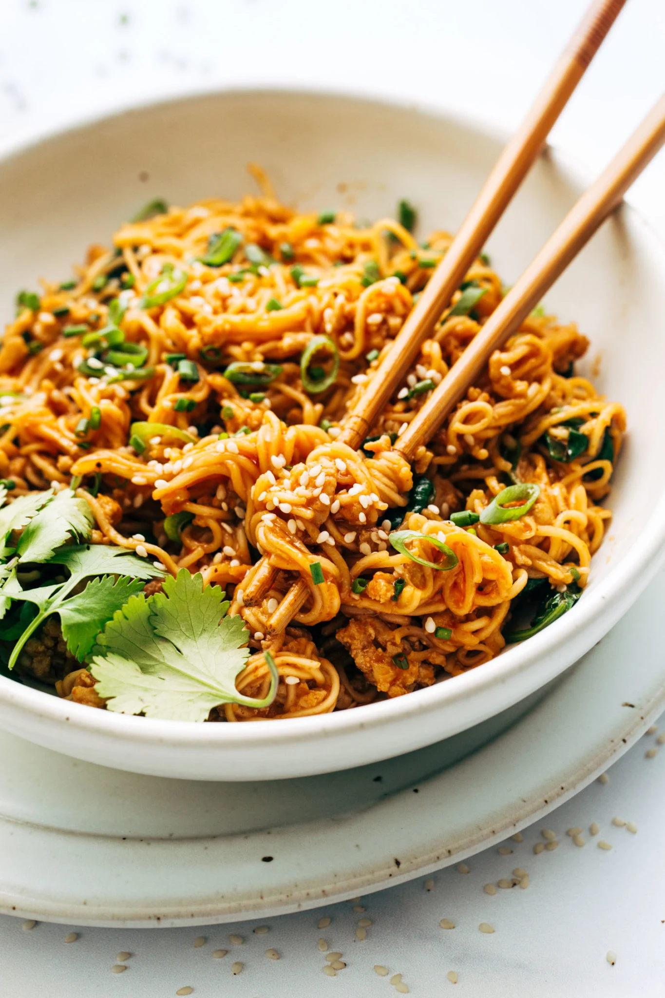 Gochujang noodles with chopsticks and coriander.