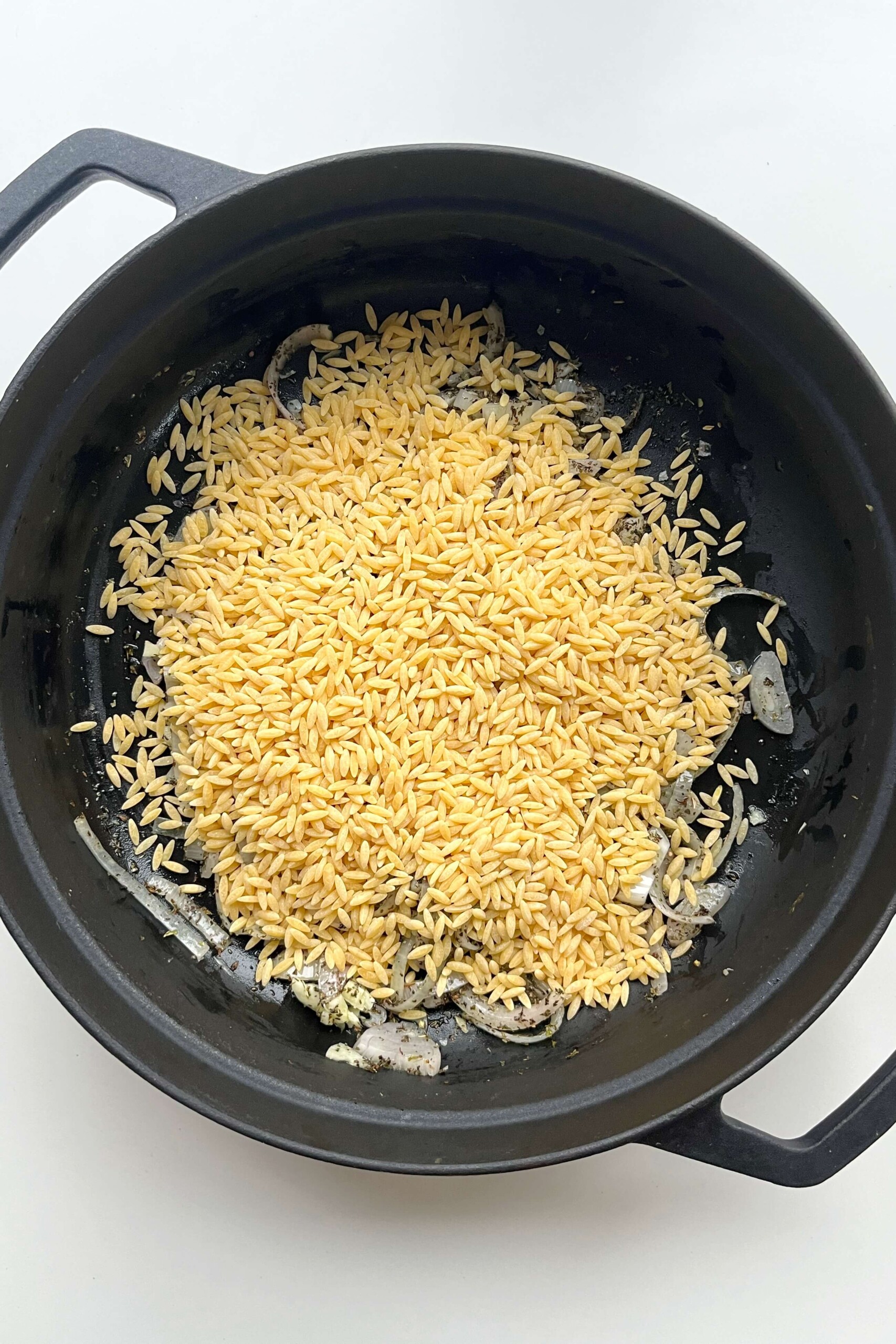 Black pan with orzo.