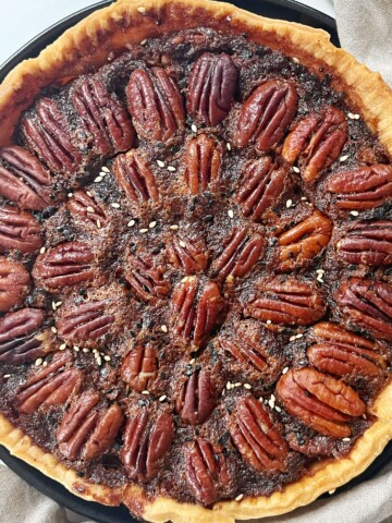 Miso Pecan Pie on a black plate.