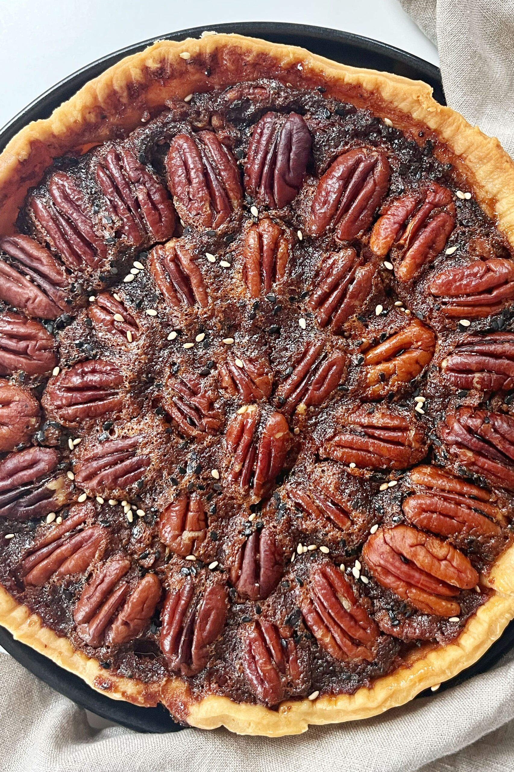 Miso Pecan Pie on a black plate.