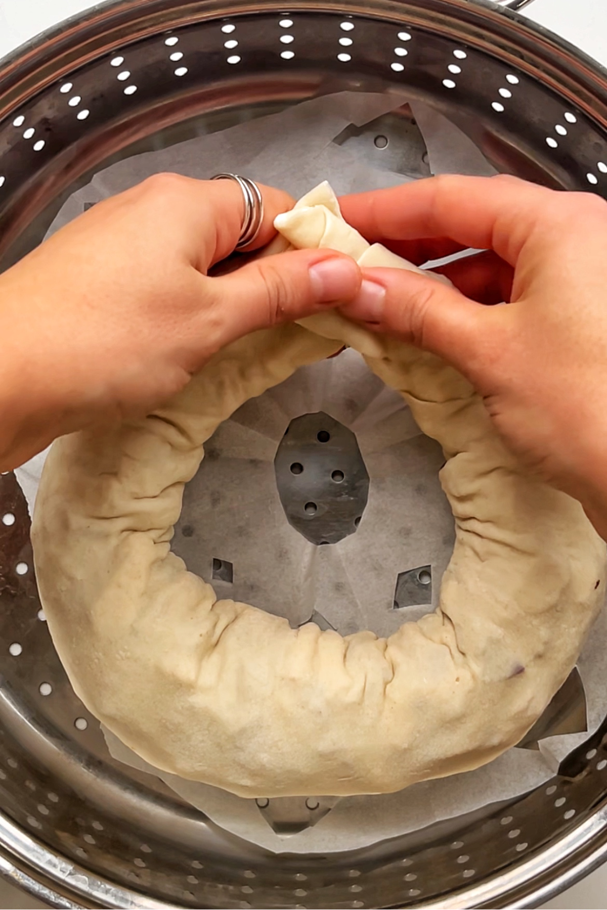 Attaching both ends of the roll together to form a wreath.