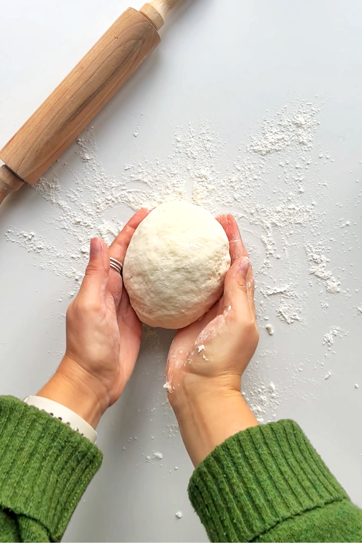 Bouncy soft dough with hands.