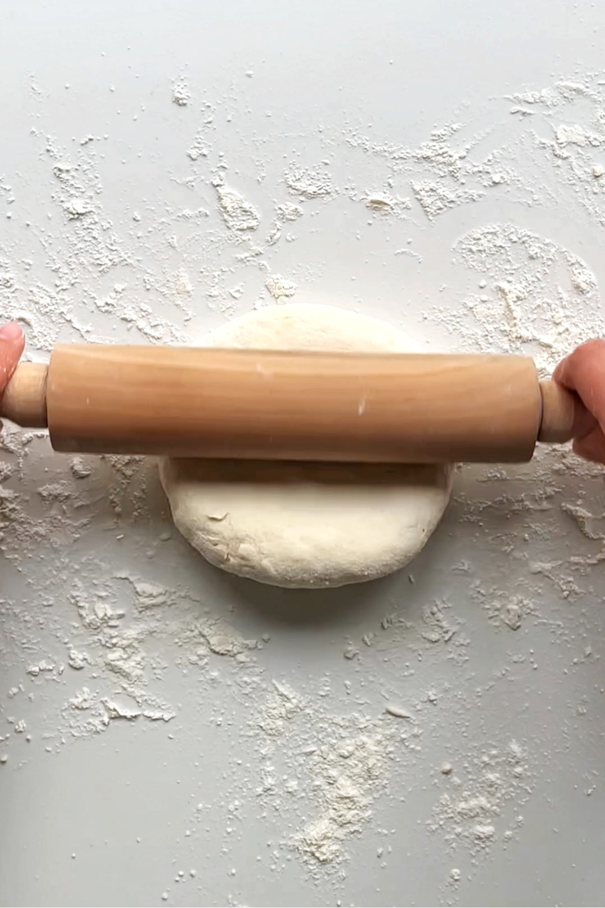 Rolling out and slightly flattening down the turkey flatbreads.