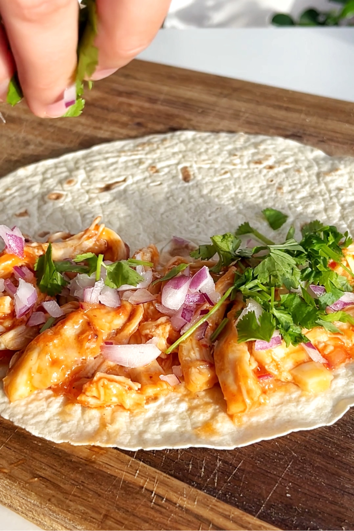 White tortilla wrap topped with fried turkey sweet chilli, onion, coriander.