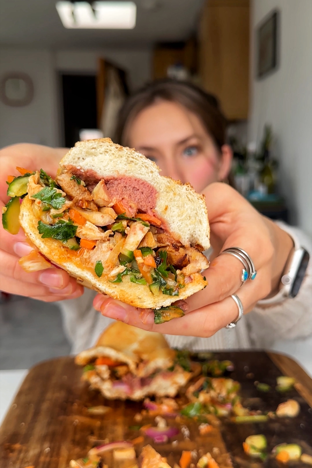 Emily Roz showing sandwich to camera.