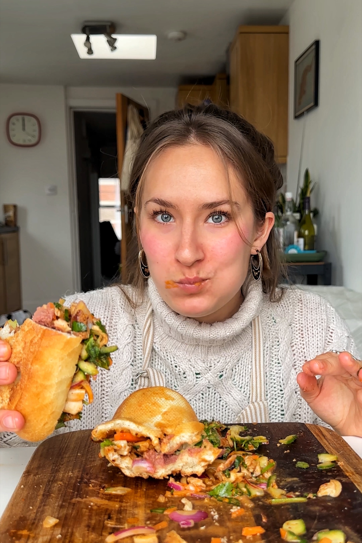 Emily Roz eating sandwich.