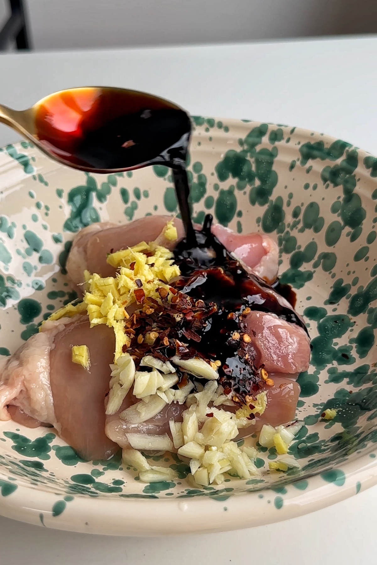 Marinating chicken in a bowl.