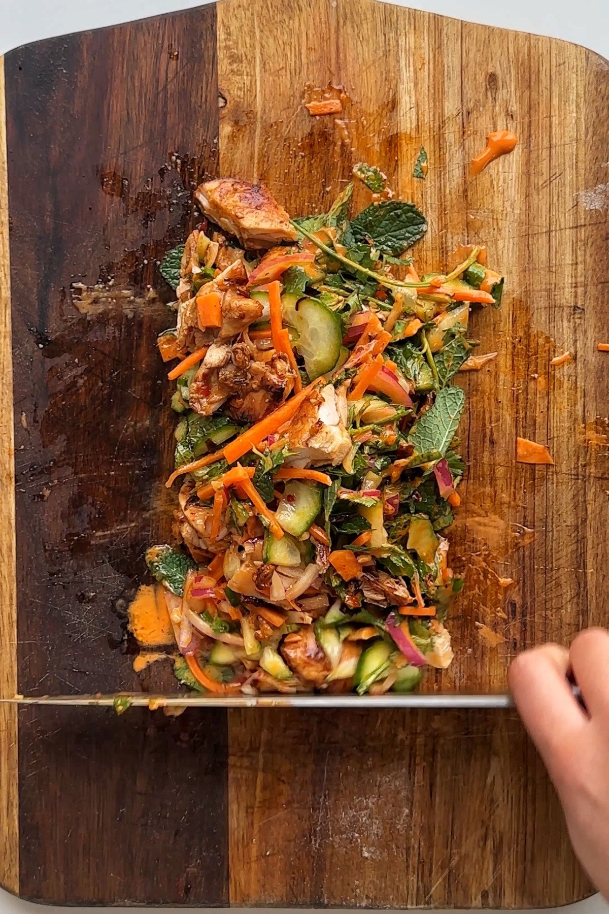 Forming the ingredients on the chopping board into a rectangle.
