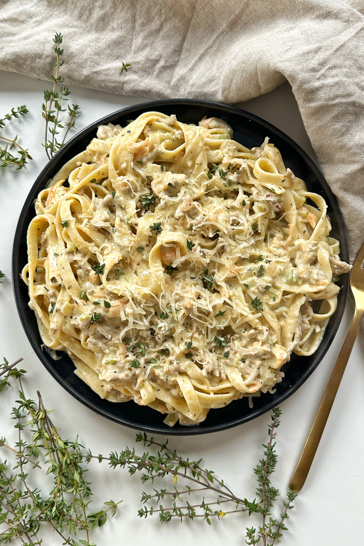 white ragu with tagliatelle on a white background. 