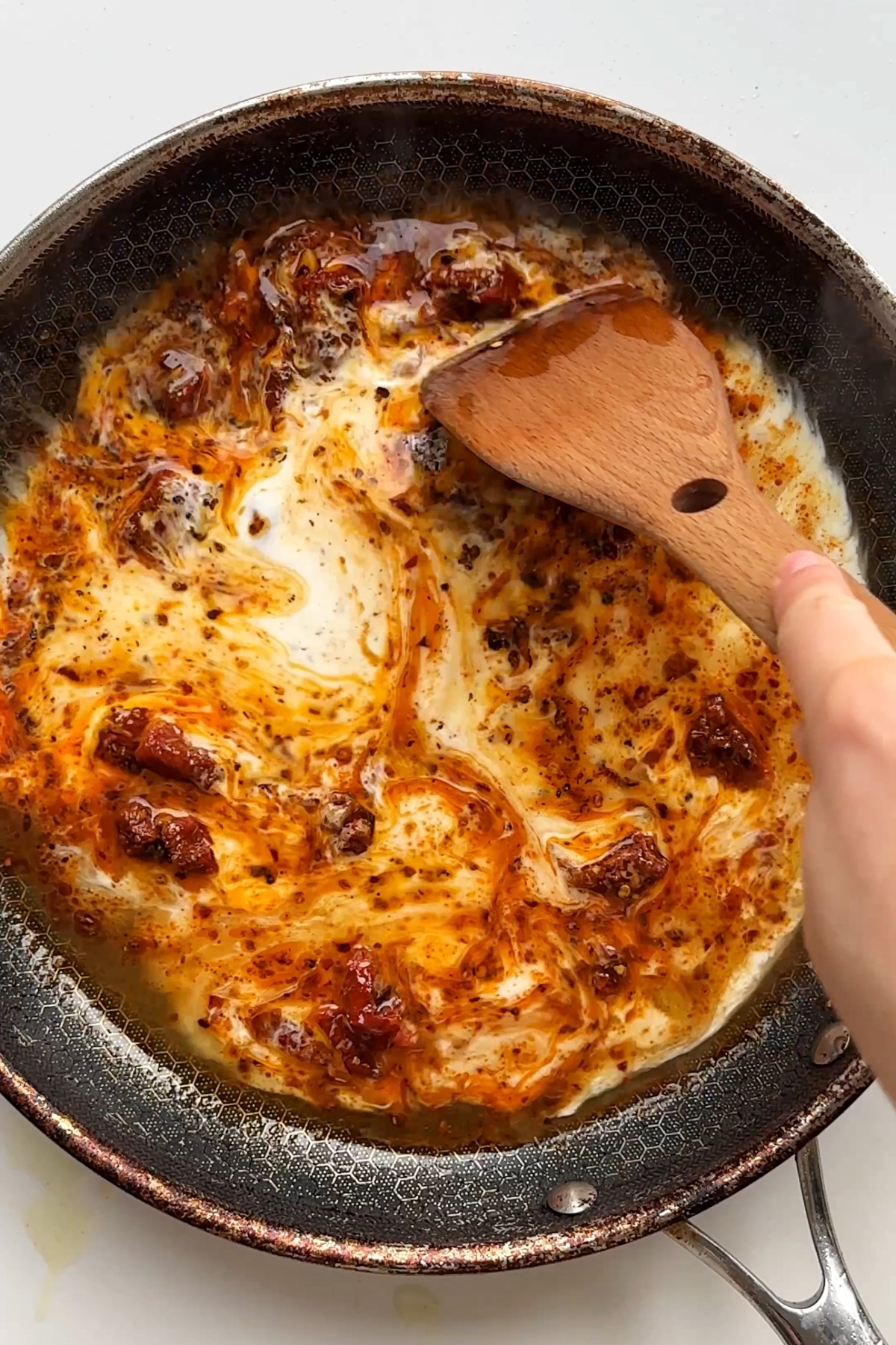 Making a marry me chicken sauce in a black frying pan. 