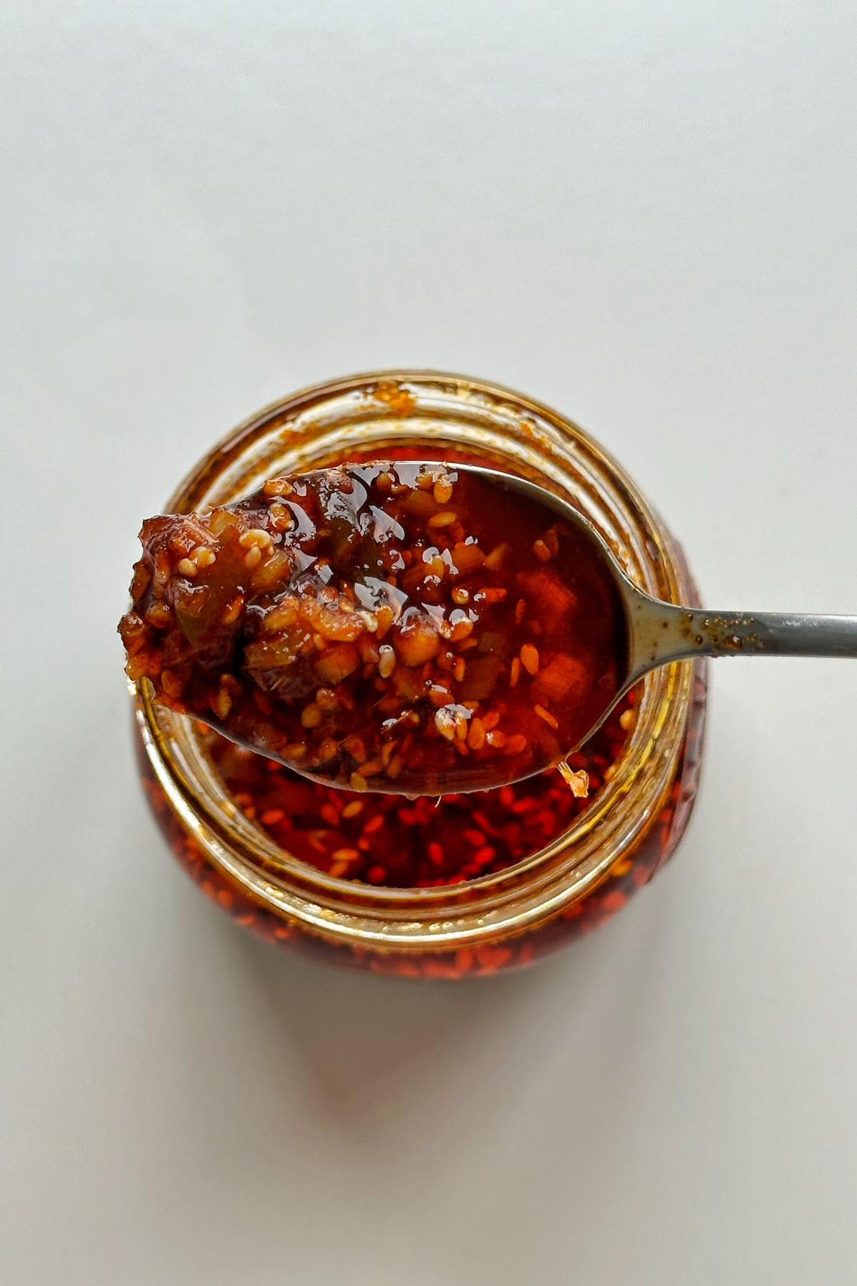 Chilli oil being picked up by spoon.