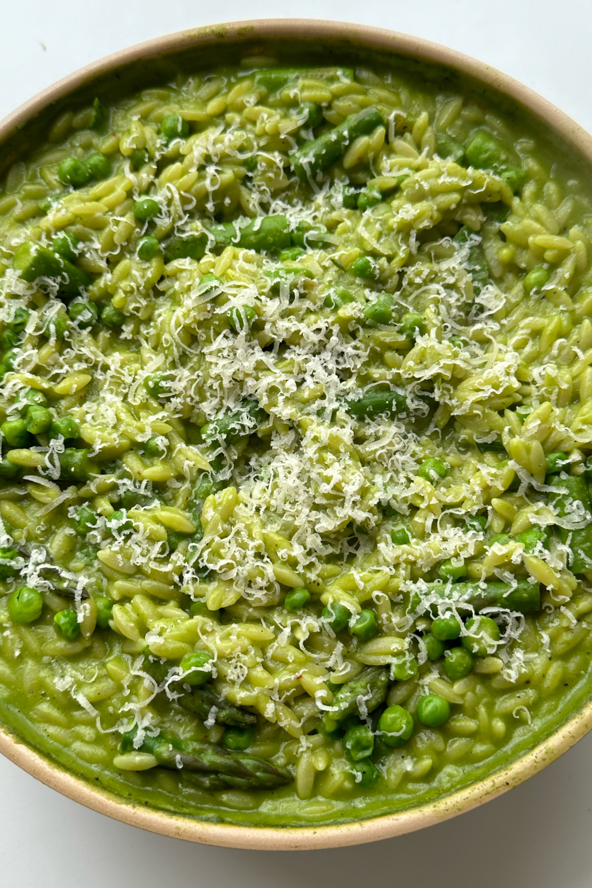 Close up of pea and asparagus pasta in a pan.