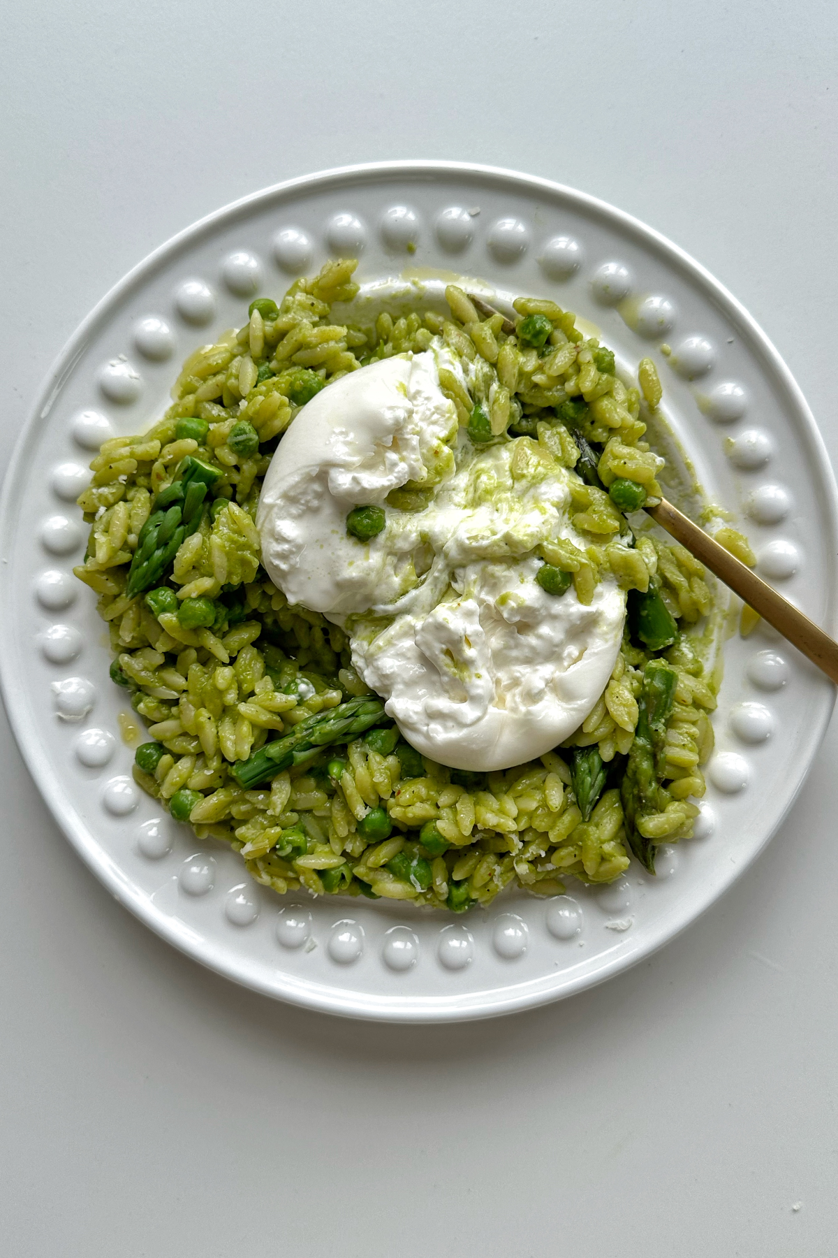 Pea and asparagus orzo with burrata on top.