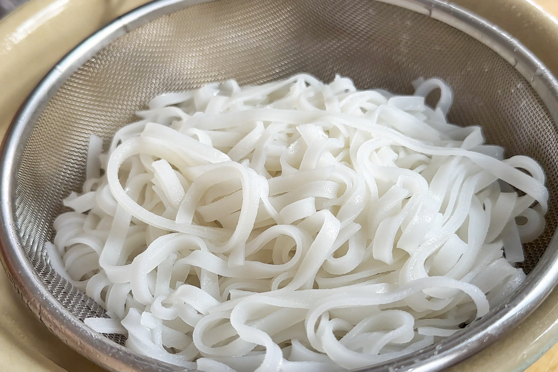 Rice noodles steaming.