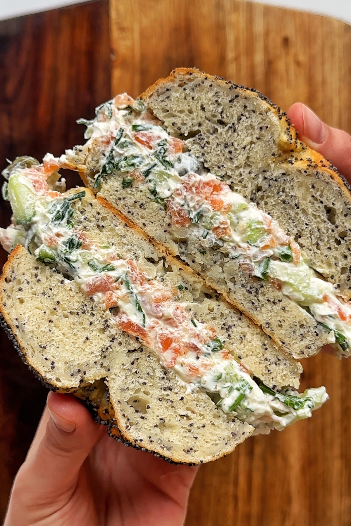 Salmon and cream cheese filling inside of a bagel.