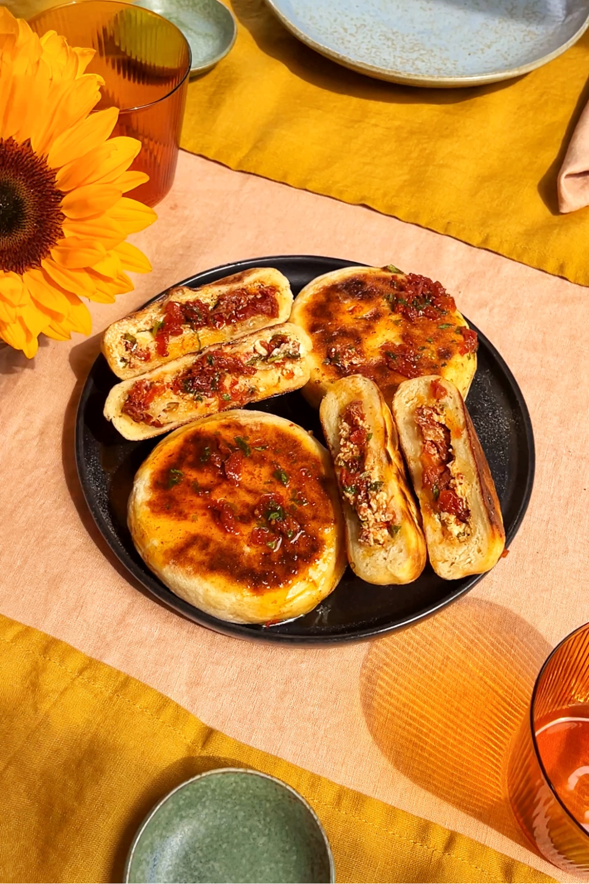 Caprese flatbreads on a black plate.