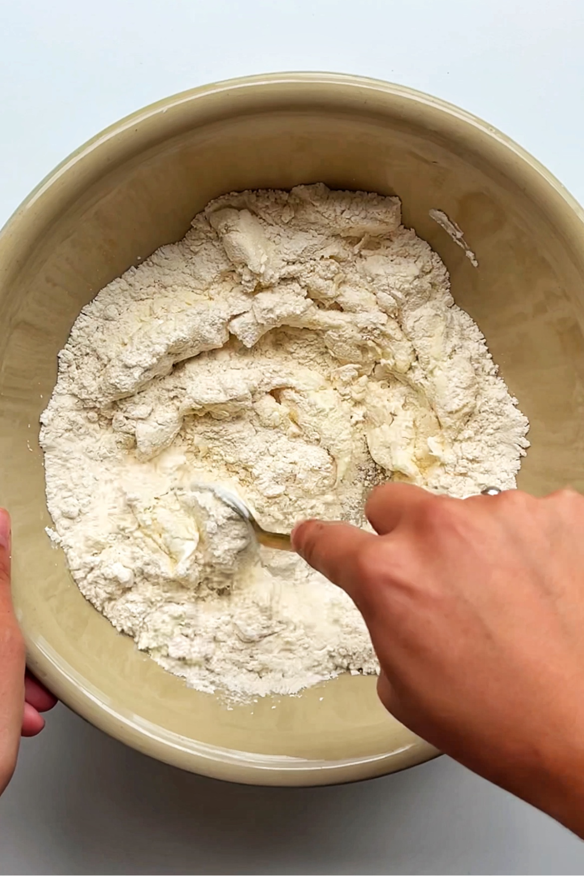 Stirring flour and greek yoghurt in a bowl.