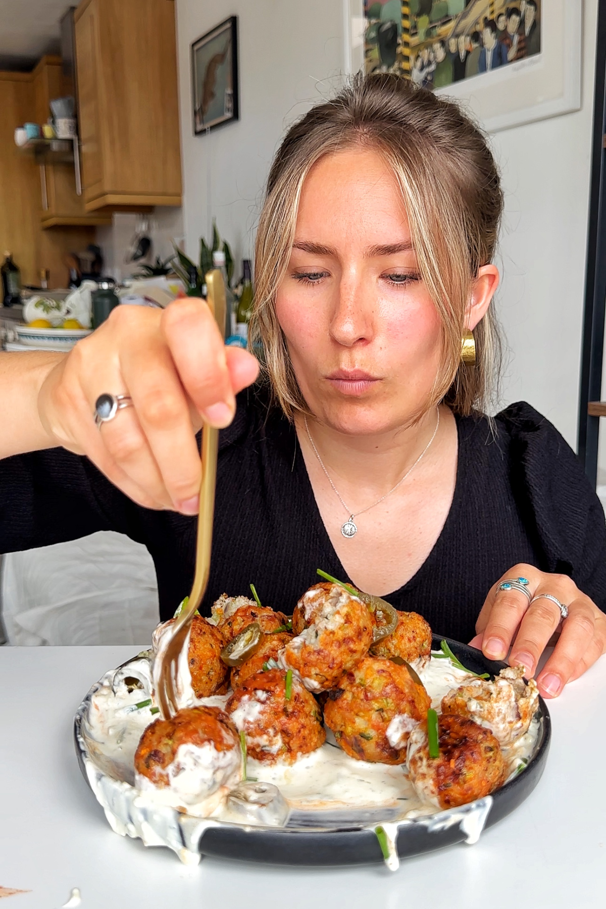 Emily Roz eating an air fryer chicken meatball.