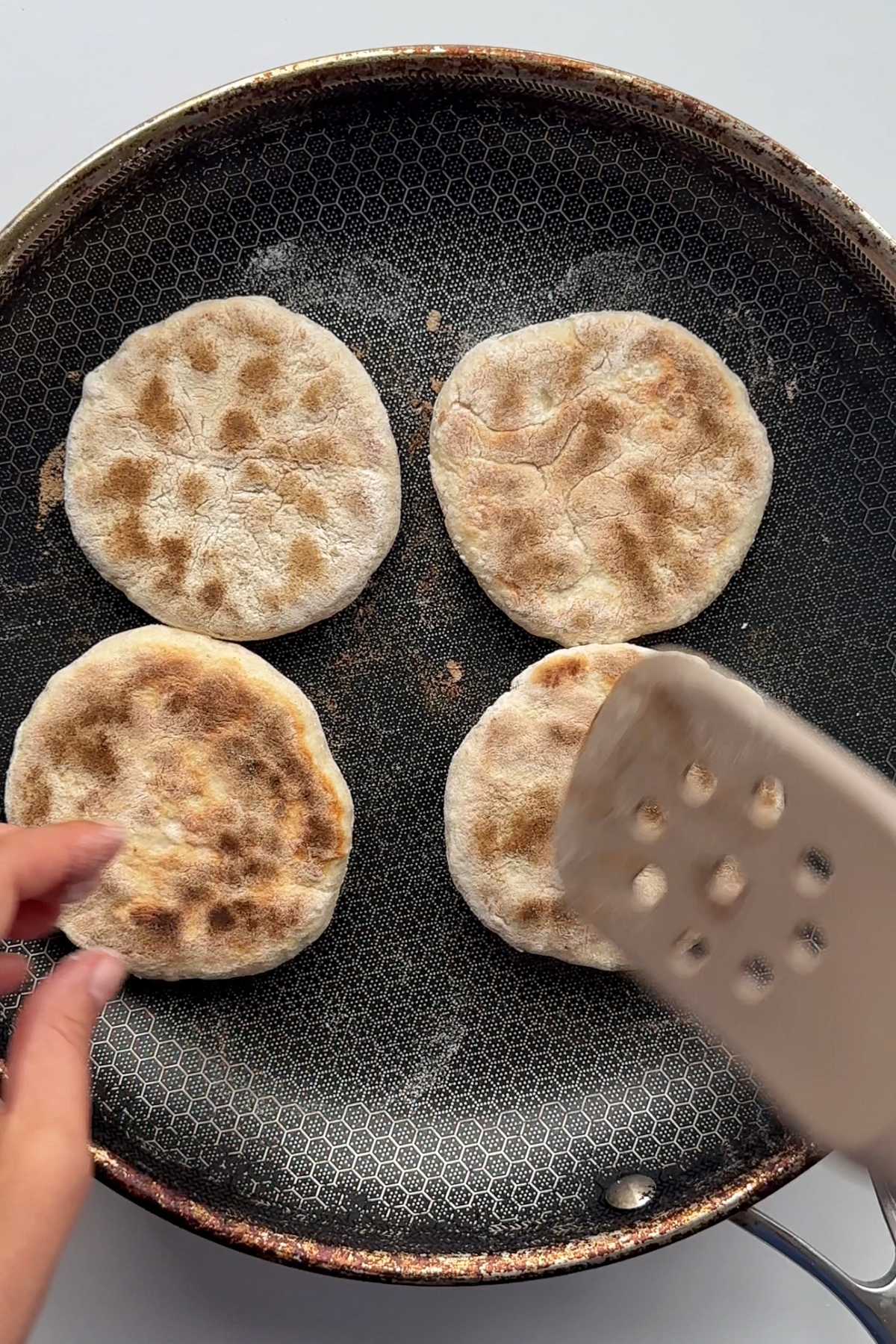 Frying cheat arepas in a frying pan.