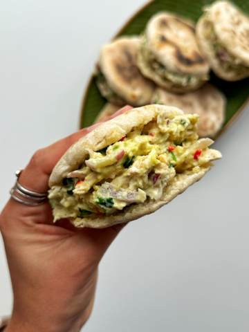 Holding up a cheat arepa with one hand.