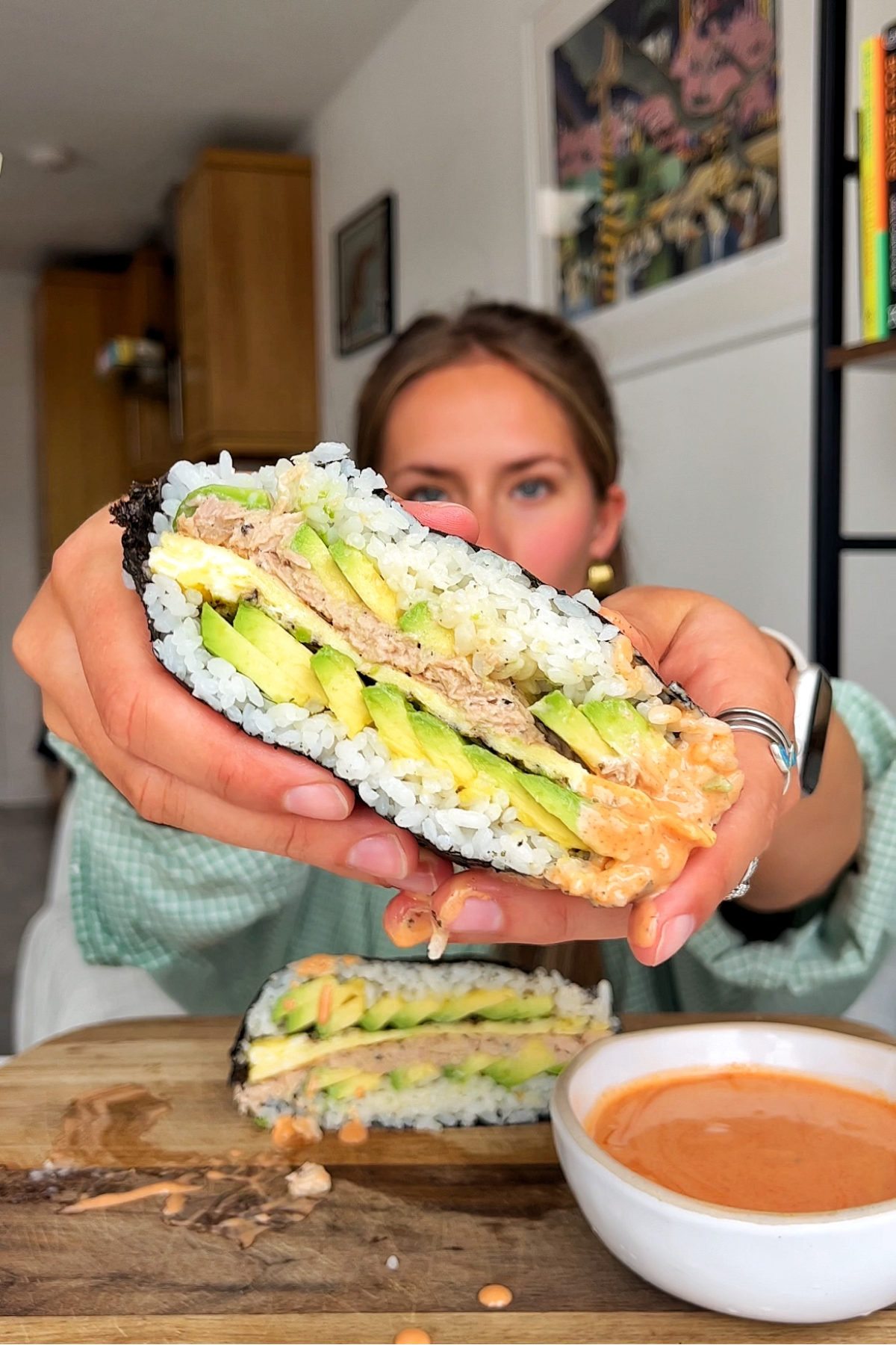Holding up an onigirazu sushi sandwich.