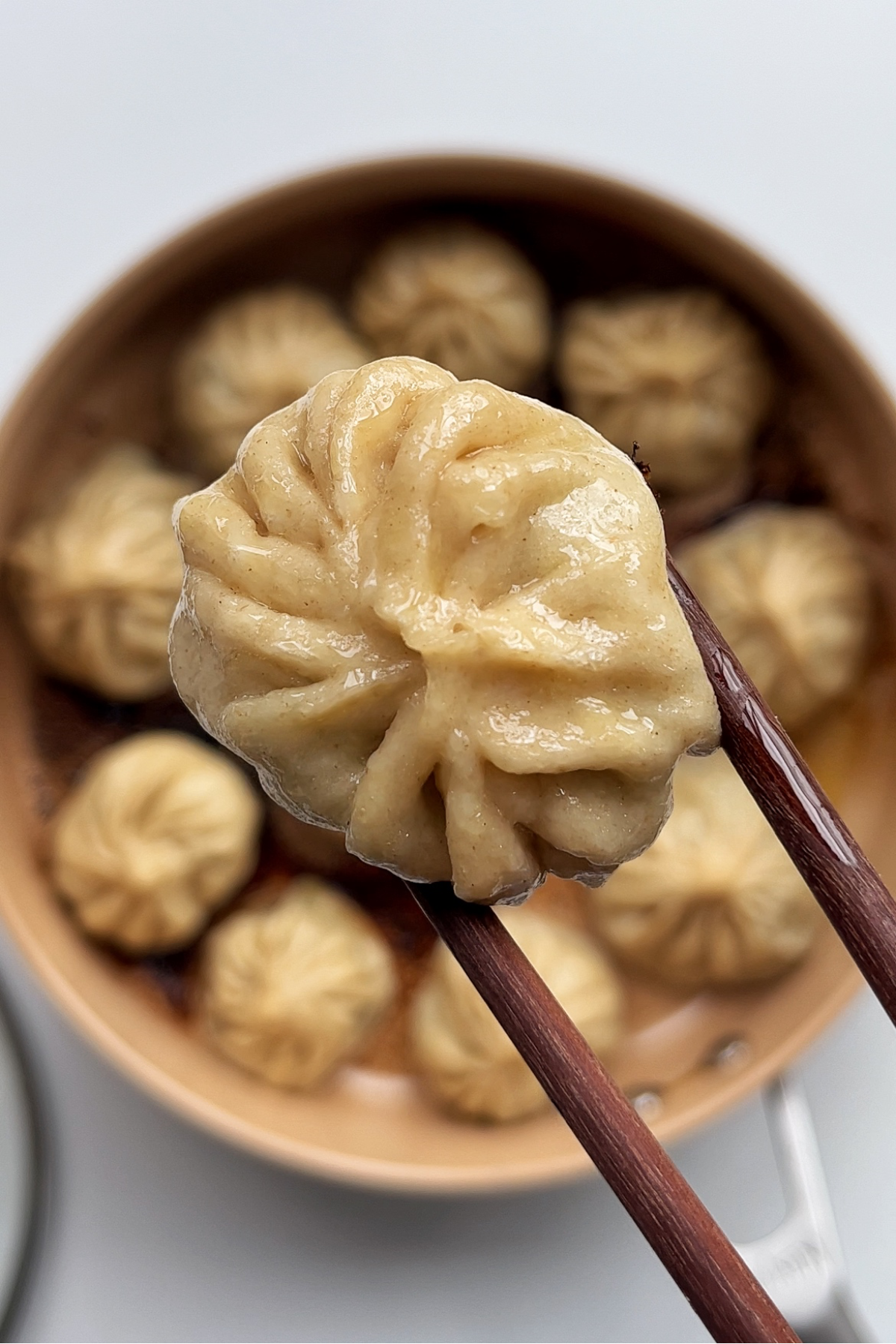 Pan-fried dumplings in a large frying pan.