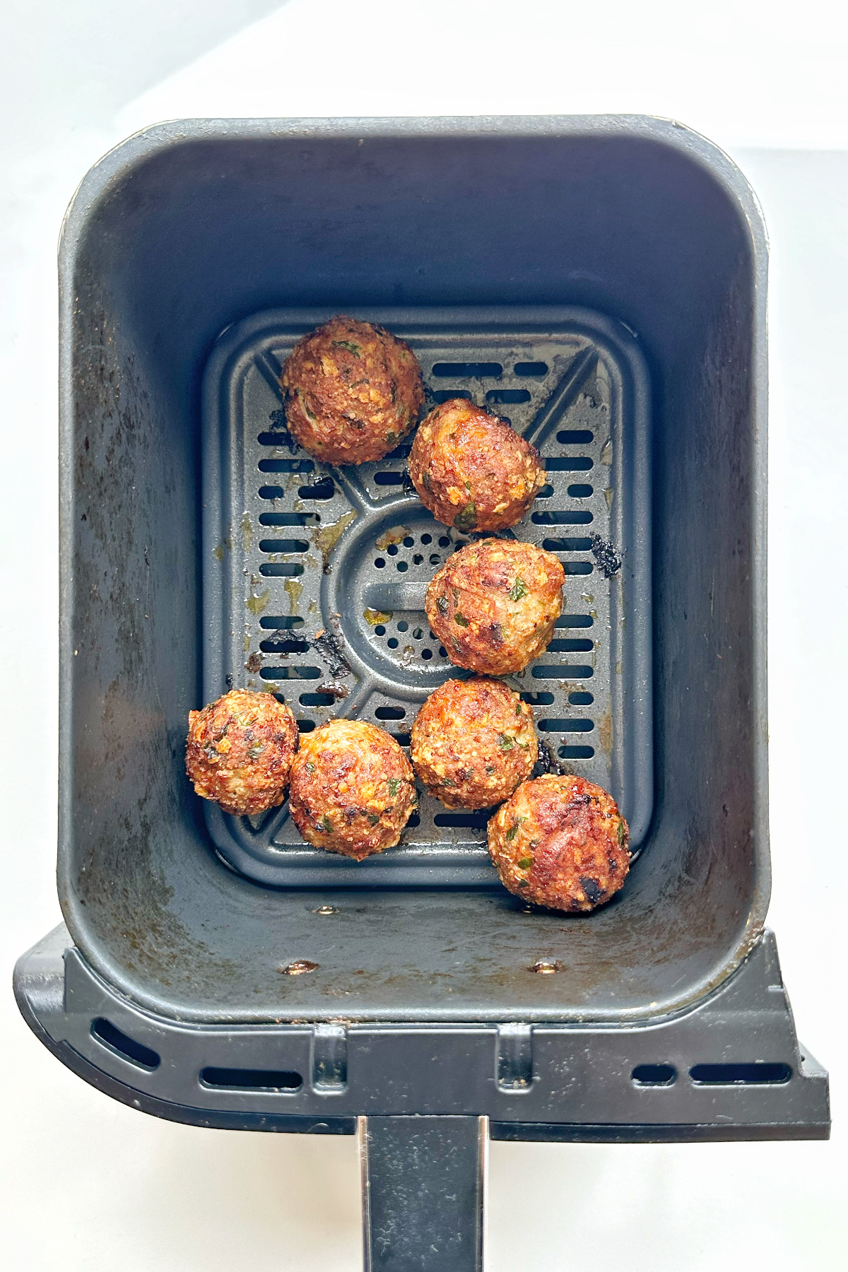Air fryer turkey meatballs cooked, in the air fryer.