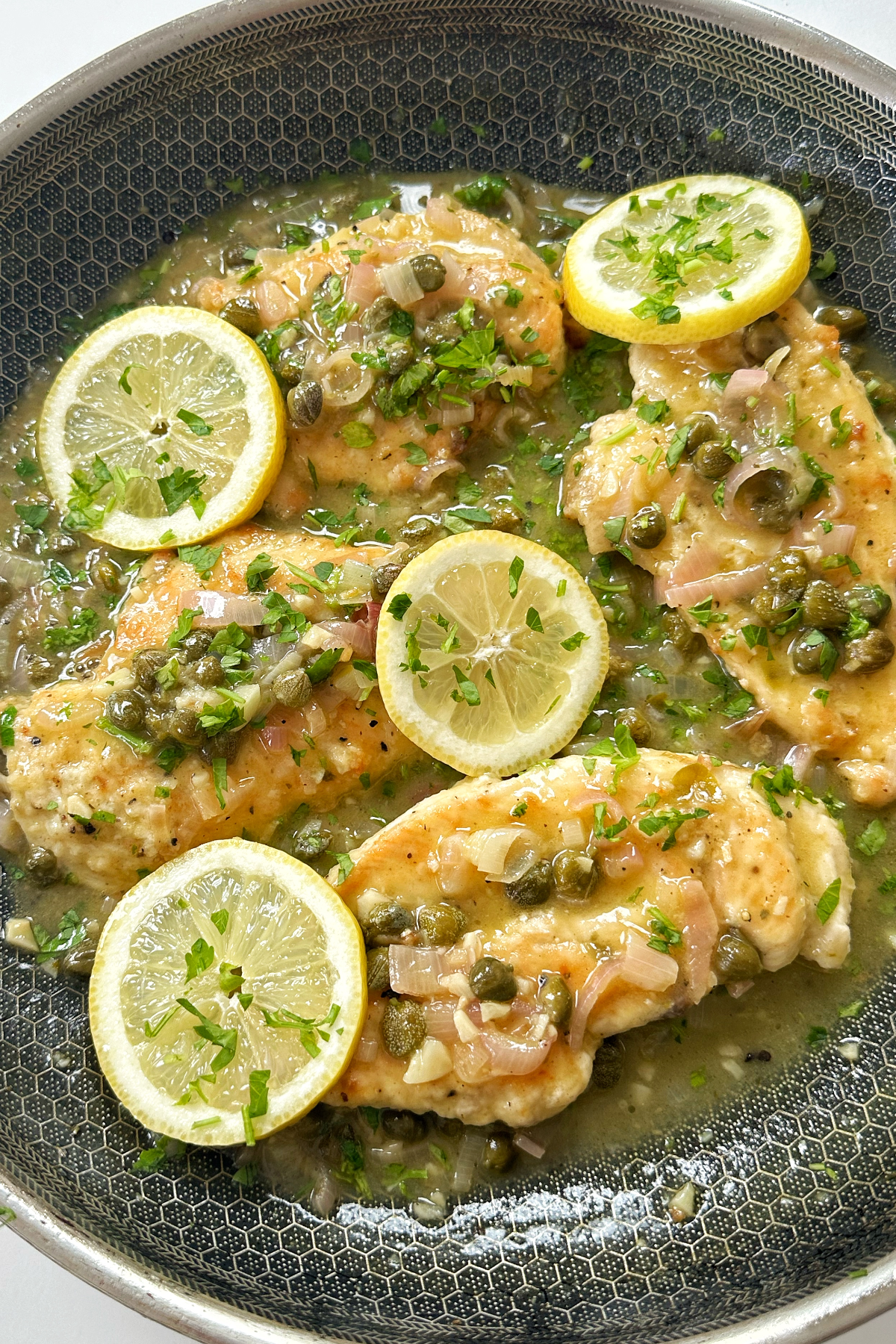 Chicken piccata in a frying pan or skillet.