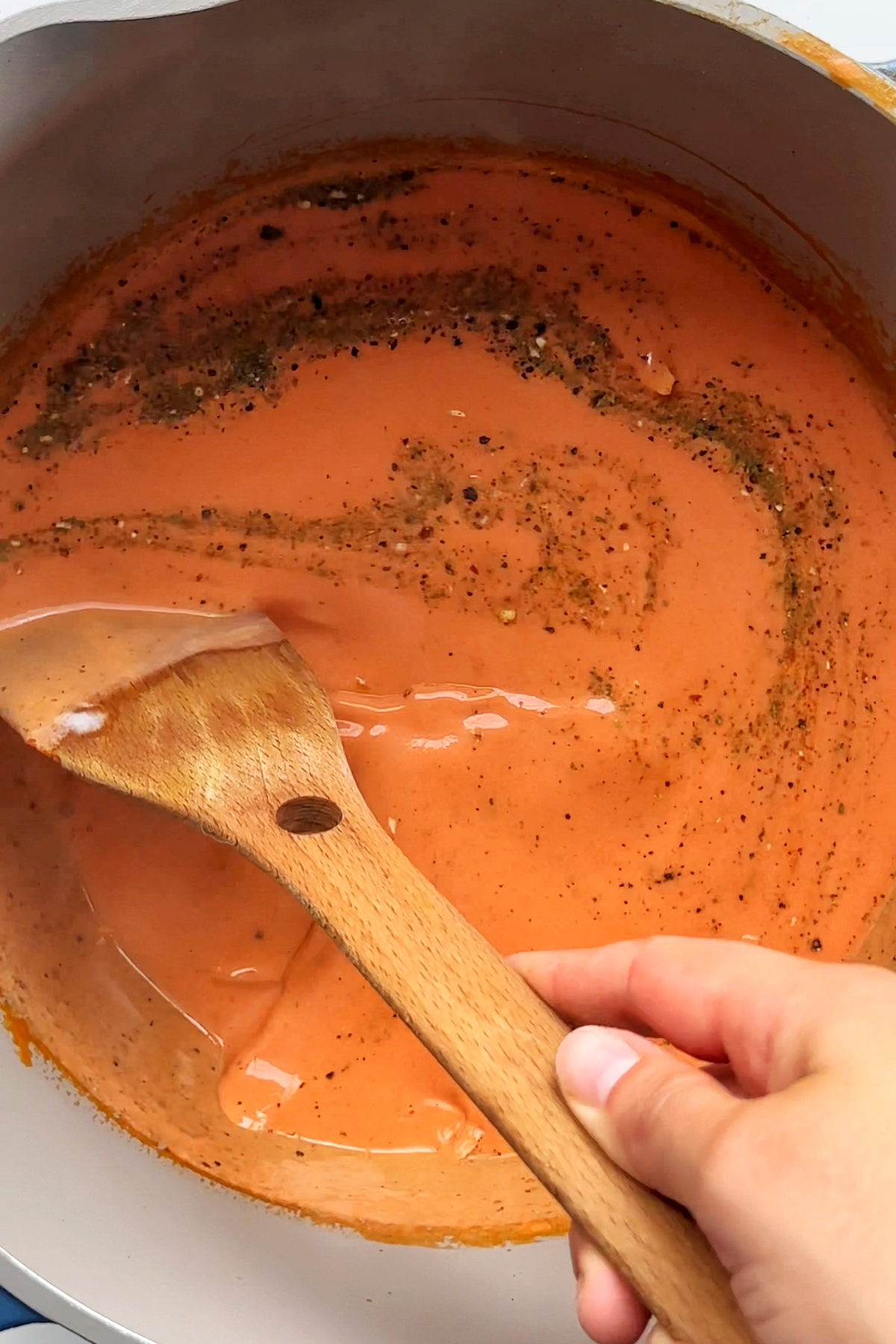 Stirring tomato soup.