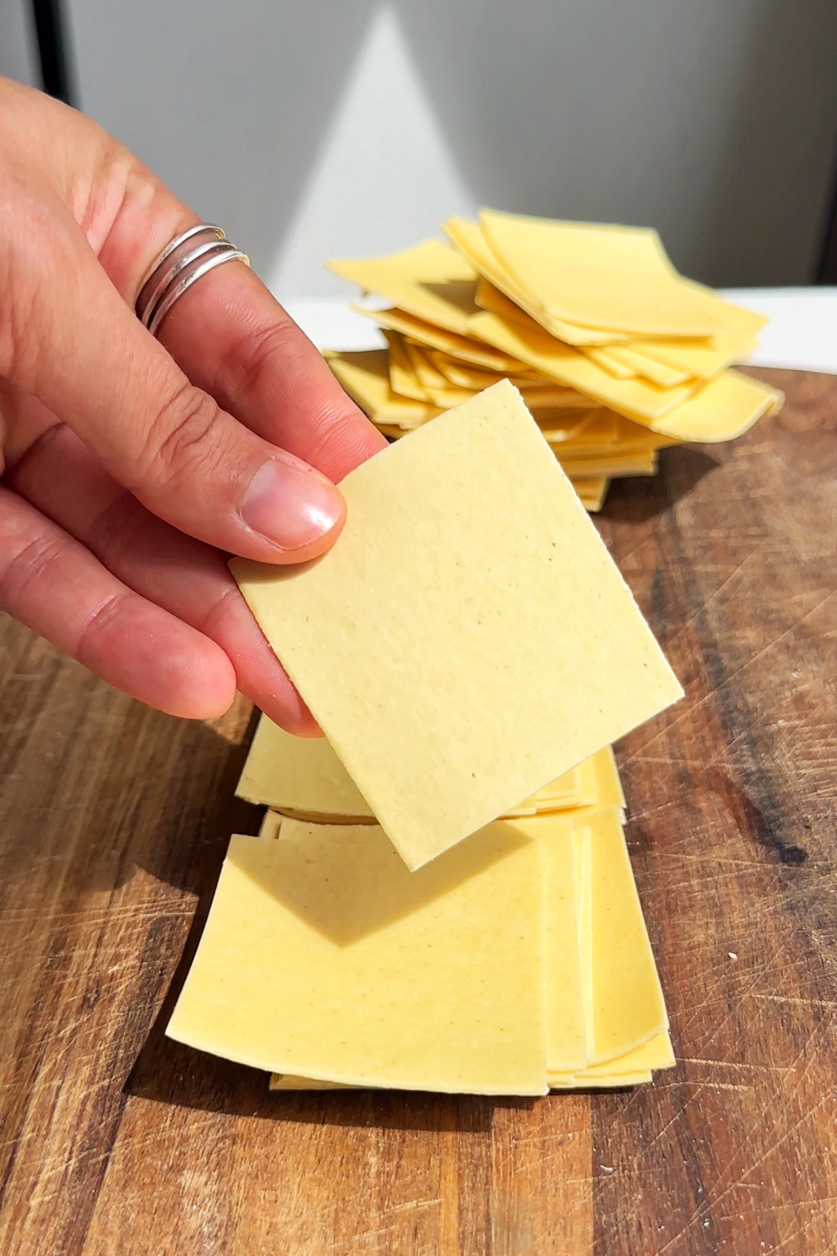 Slicing up fresh lasagne sheets to add to the soup.
