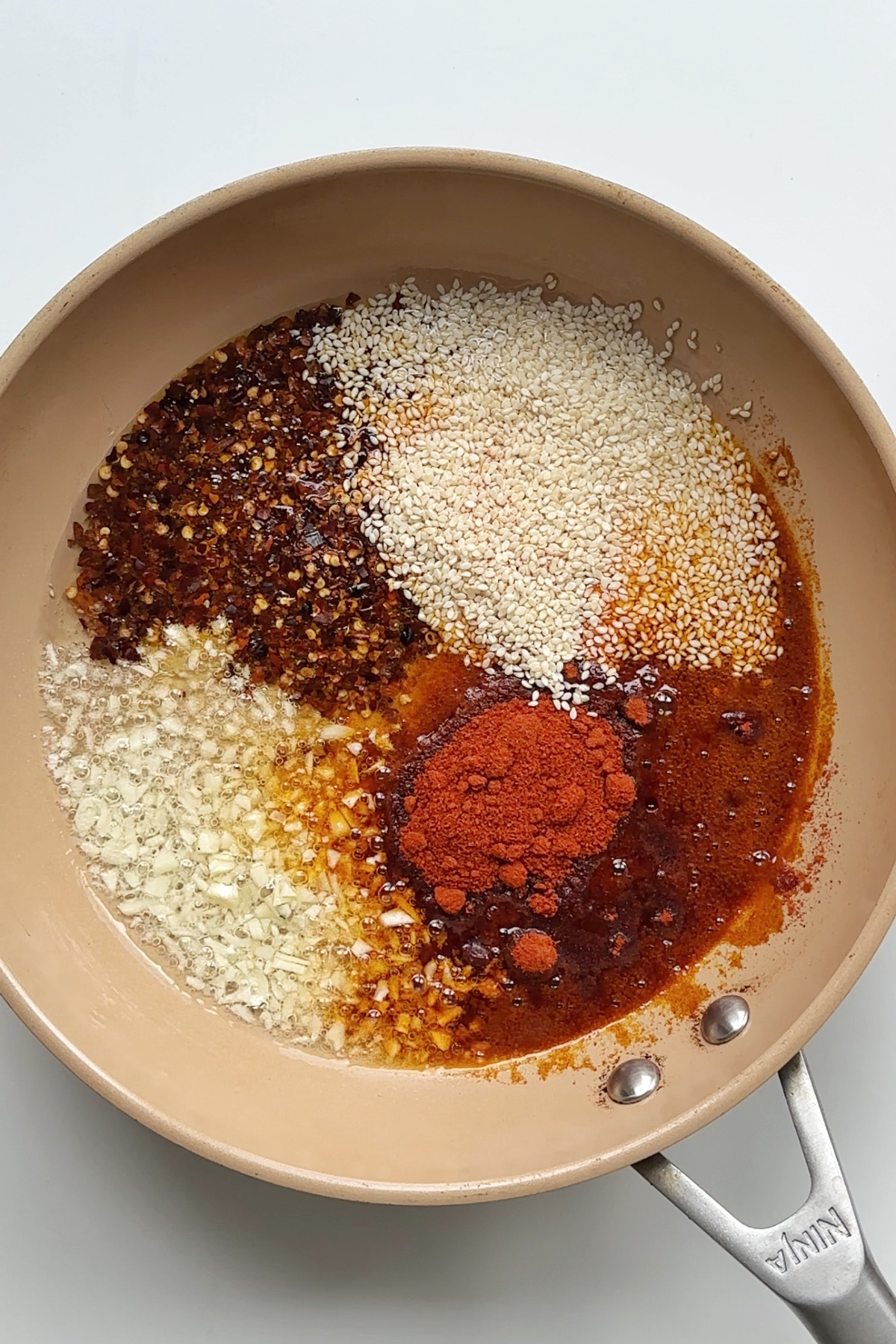 Making a chilli oil in a frying pan.
