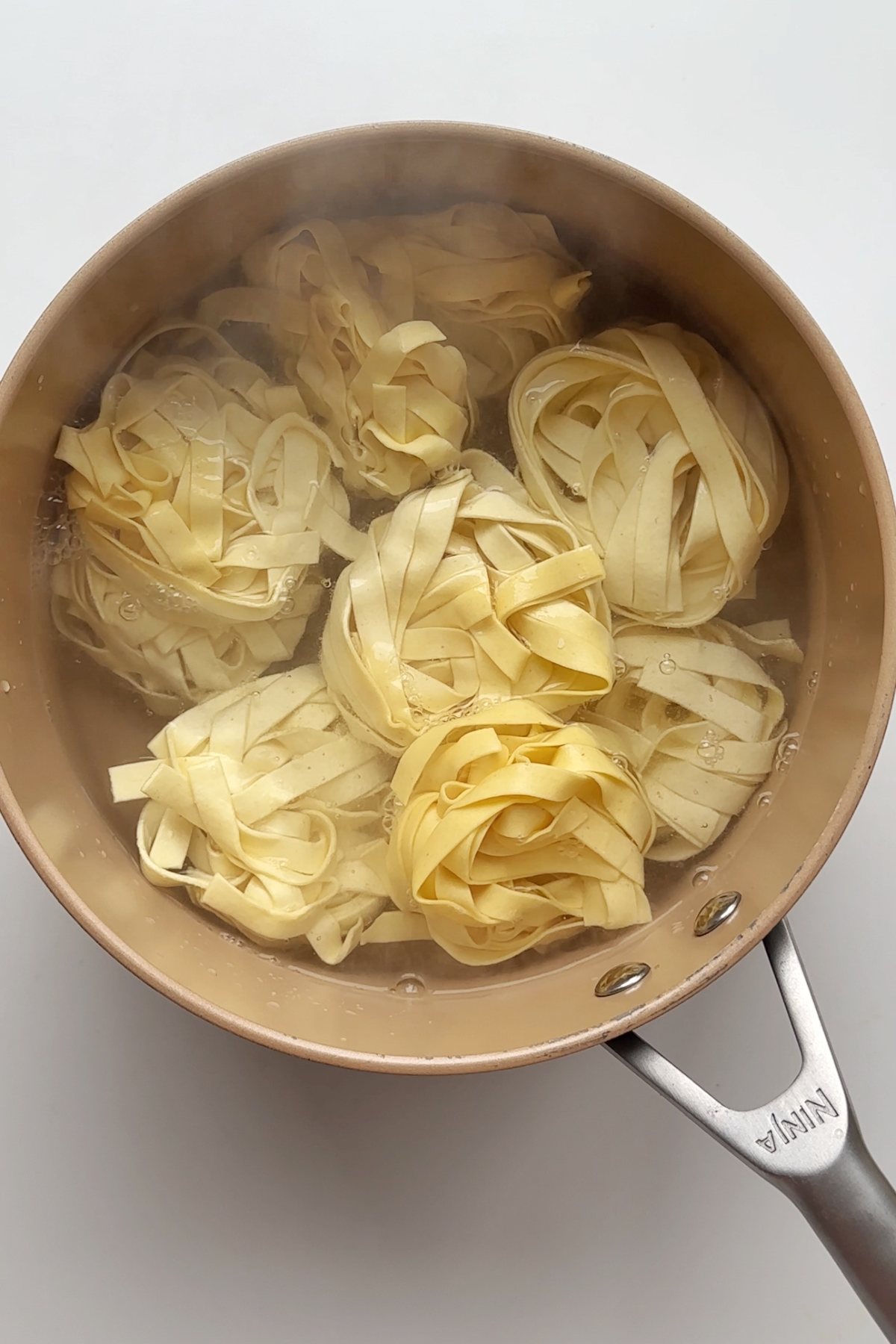 Cooking tagliatelle in a saucepan.