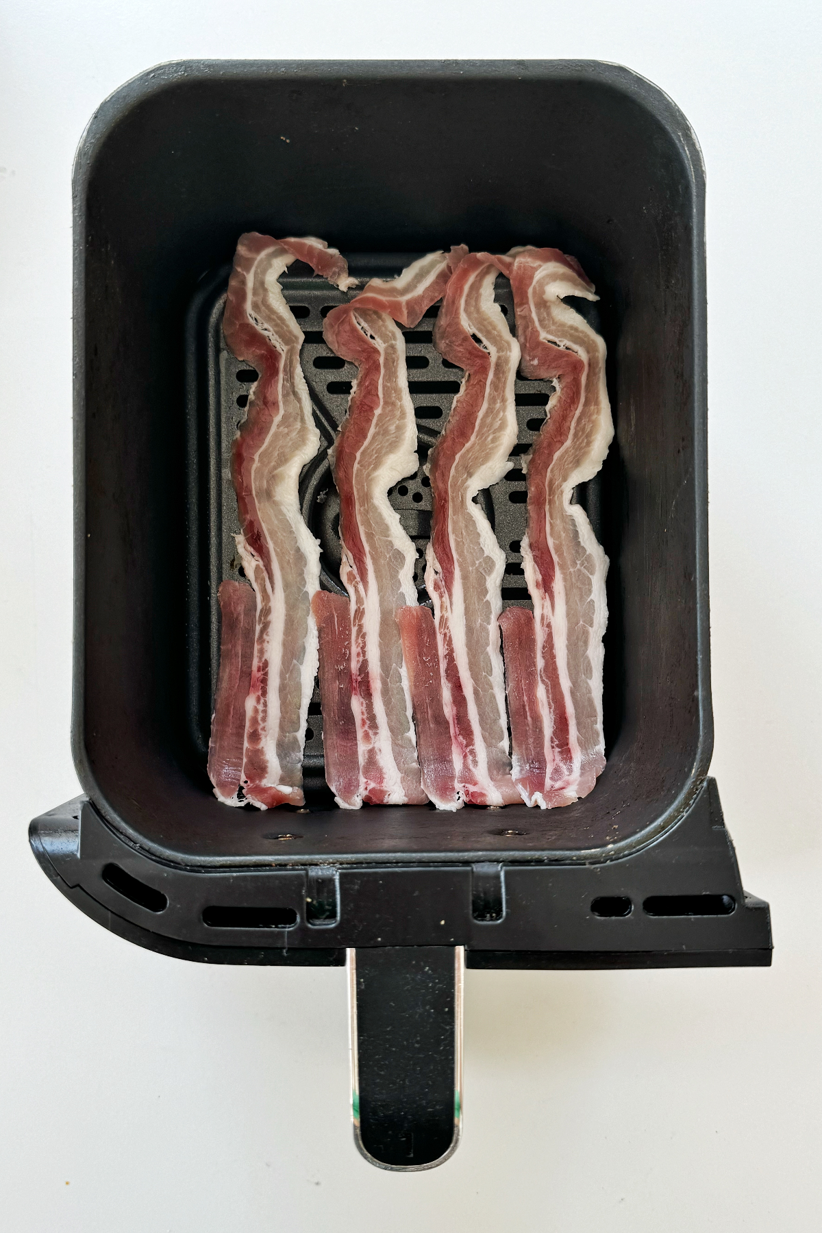 Cooking streaky bacon in the air fryer.