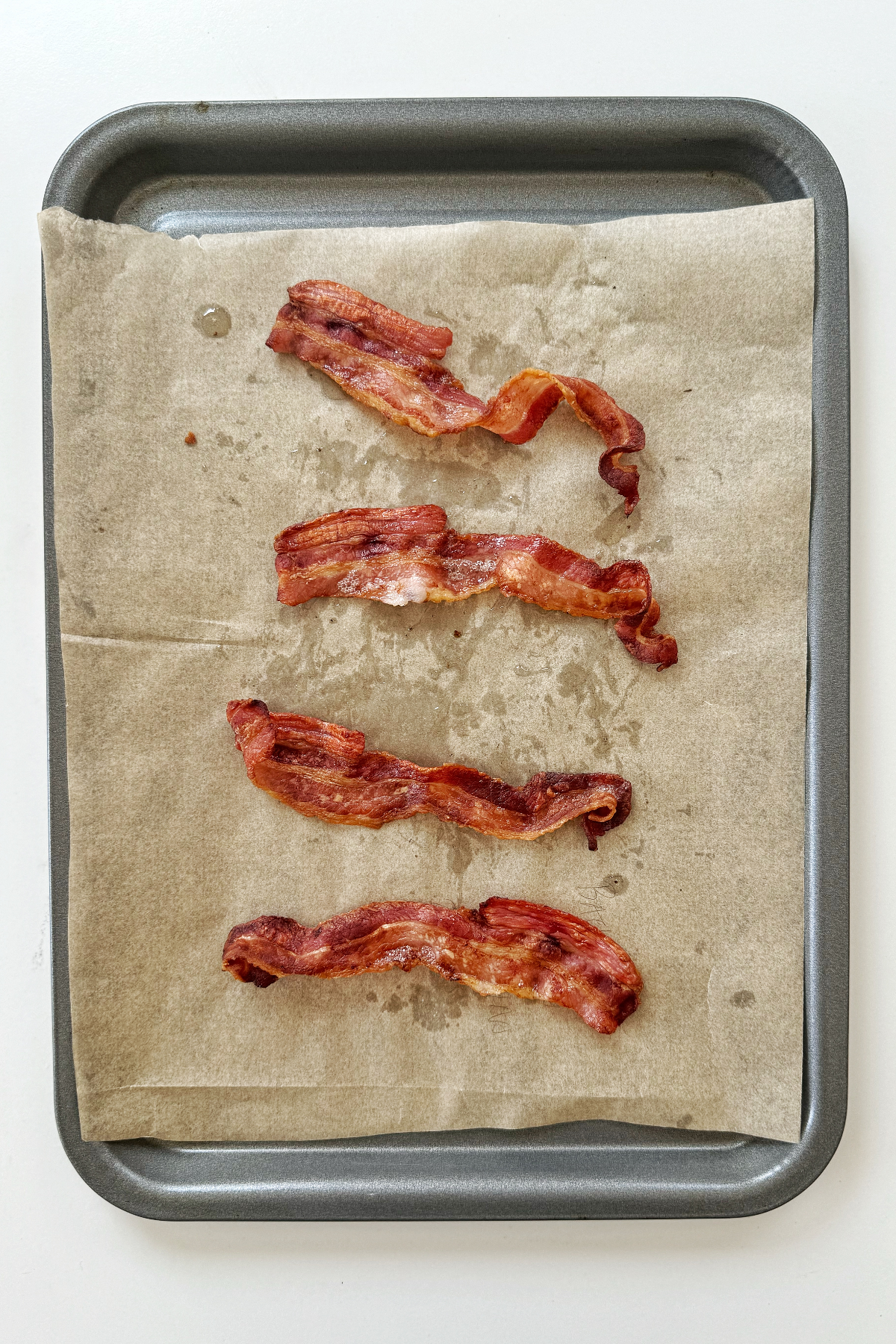 Streaky bacon on a tray.