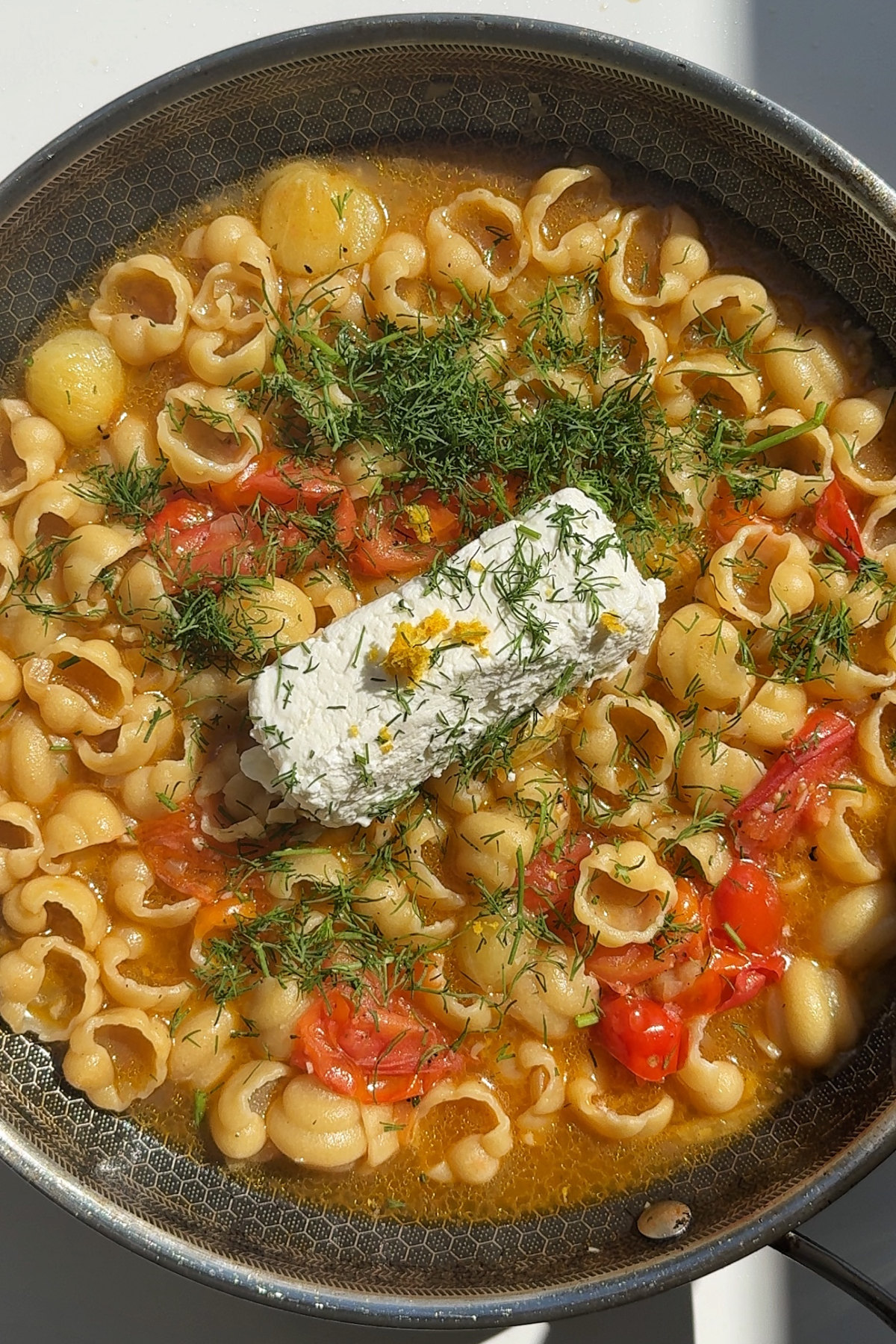 Cooking pasta with goat cheese.